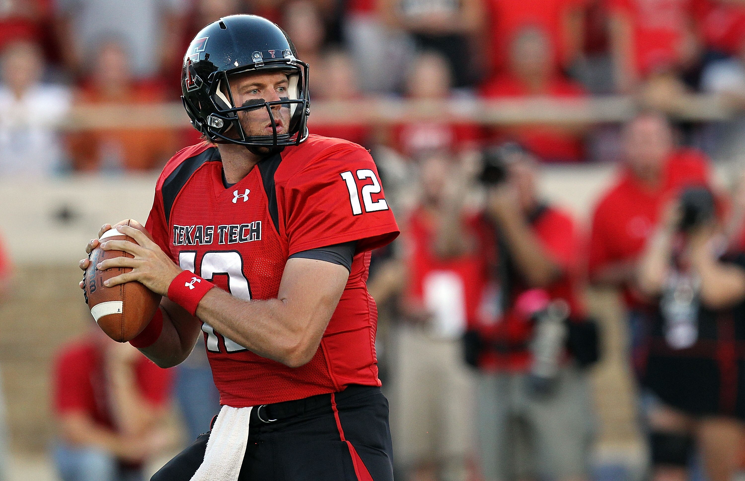 LUBBOCK, TX - SEPTEMBER 18:  Quarterback Taylor Potts #12 of the Texas Tech Red Raiders drops back to pass against the Texas Longhorns at Jones AT&T Stadium on September 18, 2010 in Lubbock, Texas.  (Photo by Ronald Martinez/Getty Images)
