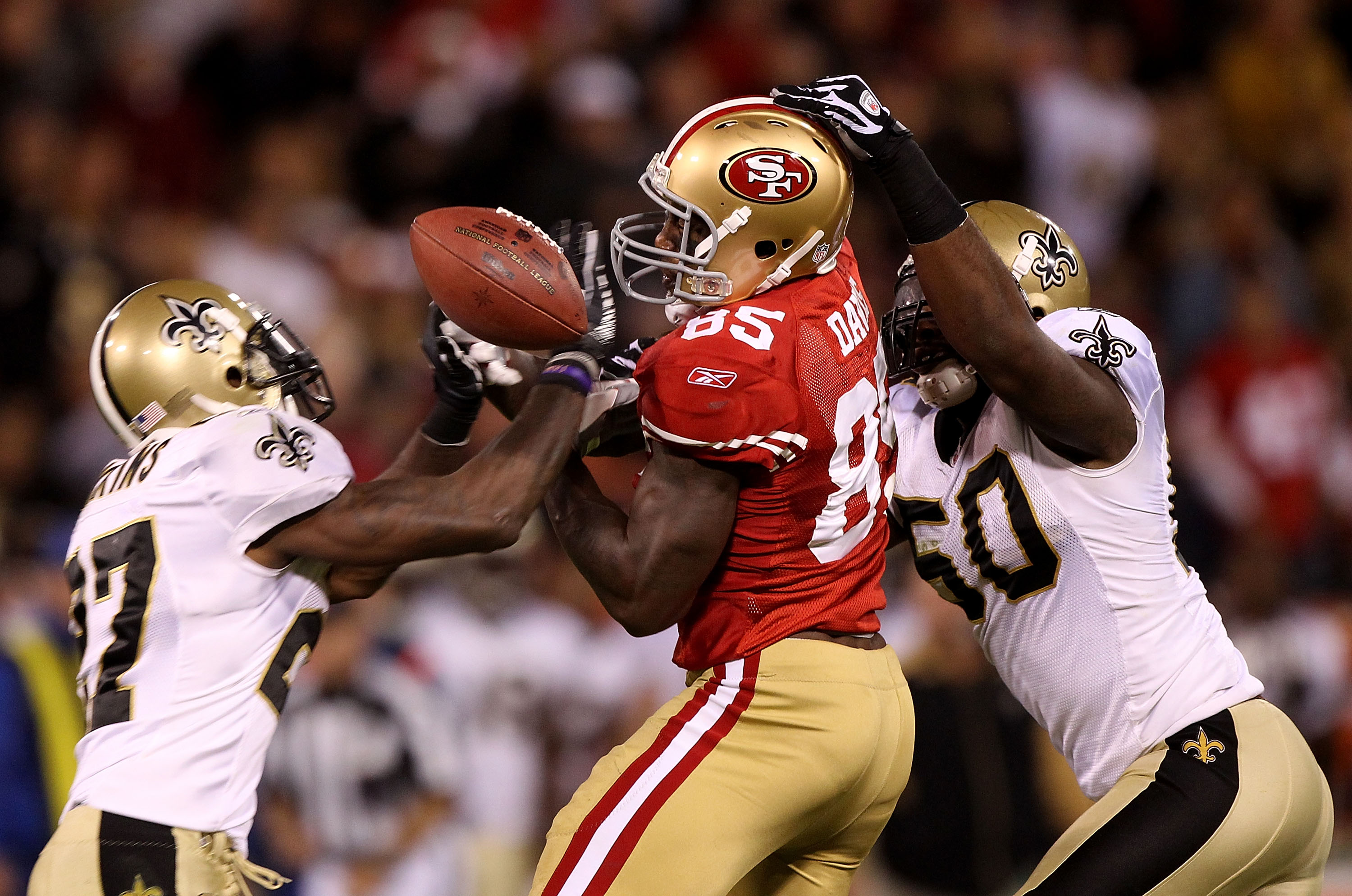 SAN FRANCISCO - SEPTEMBER 20:  Vernon Davis #85 of the San Francisco 49er fails to catch a pass as he is defended by Malcolm Jenkins #27 and Marvin Mitchell #50 of the New Orleans Saints during an NFL game at Candlestick Park on September 20, 2010 in San