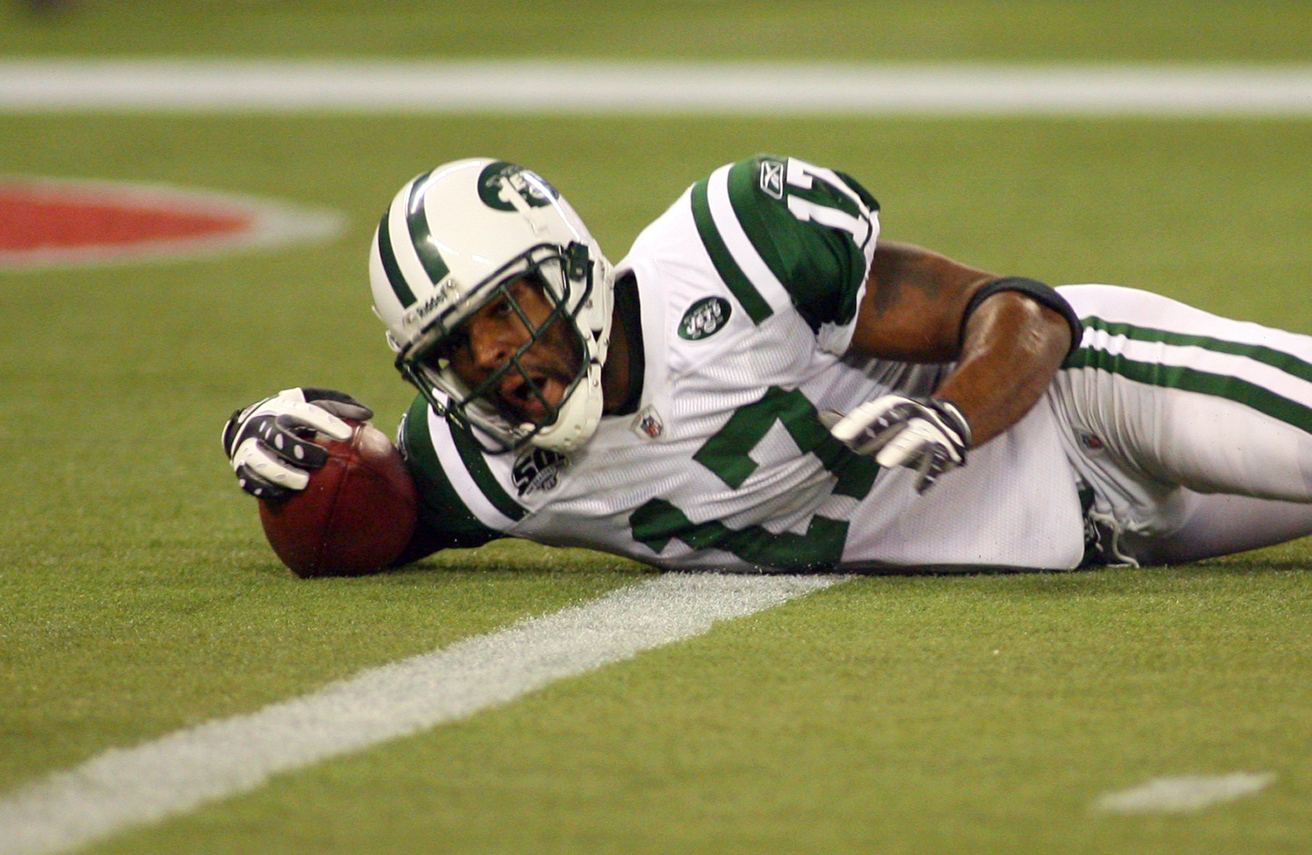 TORONTO - DECEMBER 3:  Braylon Edwards #17 of the New York Jets falls with the ball in the end zone for a touchdown during their NFL game against the Buffalo Bills on December 3, 2009  at Rogers Centre in Toronto, Ontario, Canada. The Jets defeated the Bi