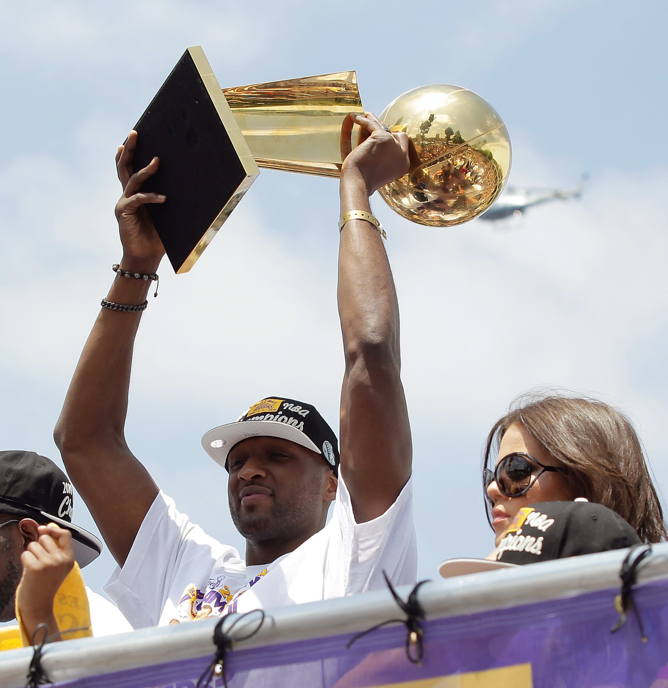 LOS ANGELES, CA - JUNE 21:  Los Angeles Lakers power foward Lamar Odom hoists the championship trophy while riding in the victory parade for the the NBA basketball champion team on June 21, 2010 in Los Angeles, California. The Lakers beat the Boston Celti