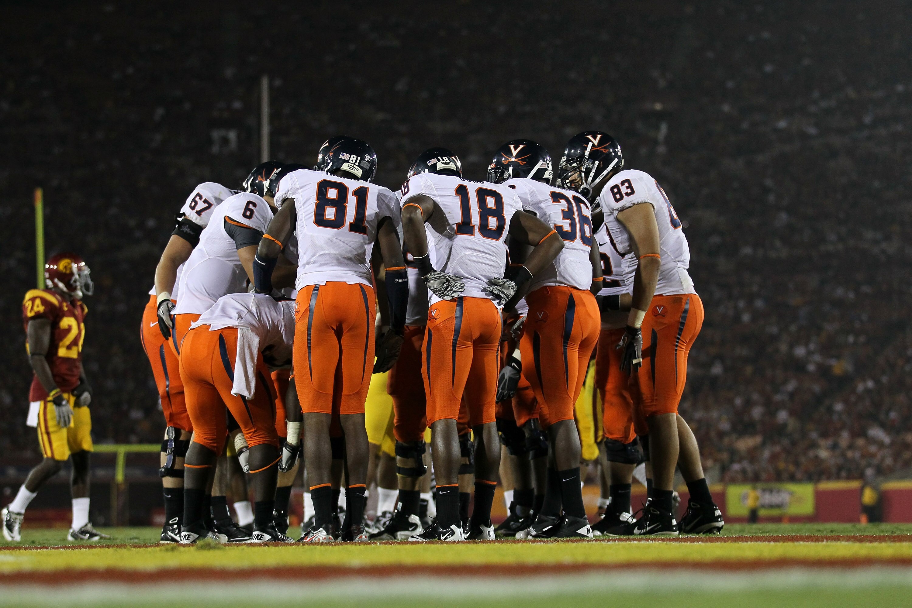 LOS ANGELES - SEPTEMBER 11:  The Virginia Cavaliers offense huddles with their backs to their goal line against the USC Trojans at Los Angeles Memorial Coliseum on September 11, 2010 in Los Angeles, California. (Photo by Stephen Dunn/Getty Images)