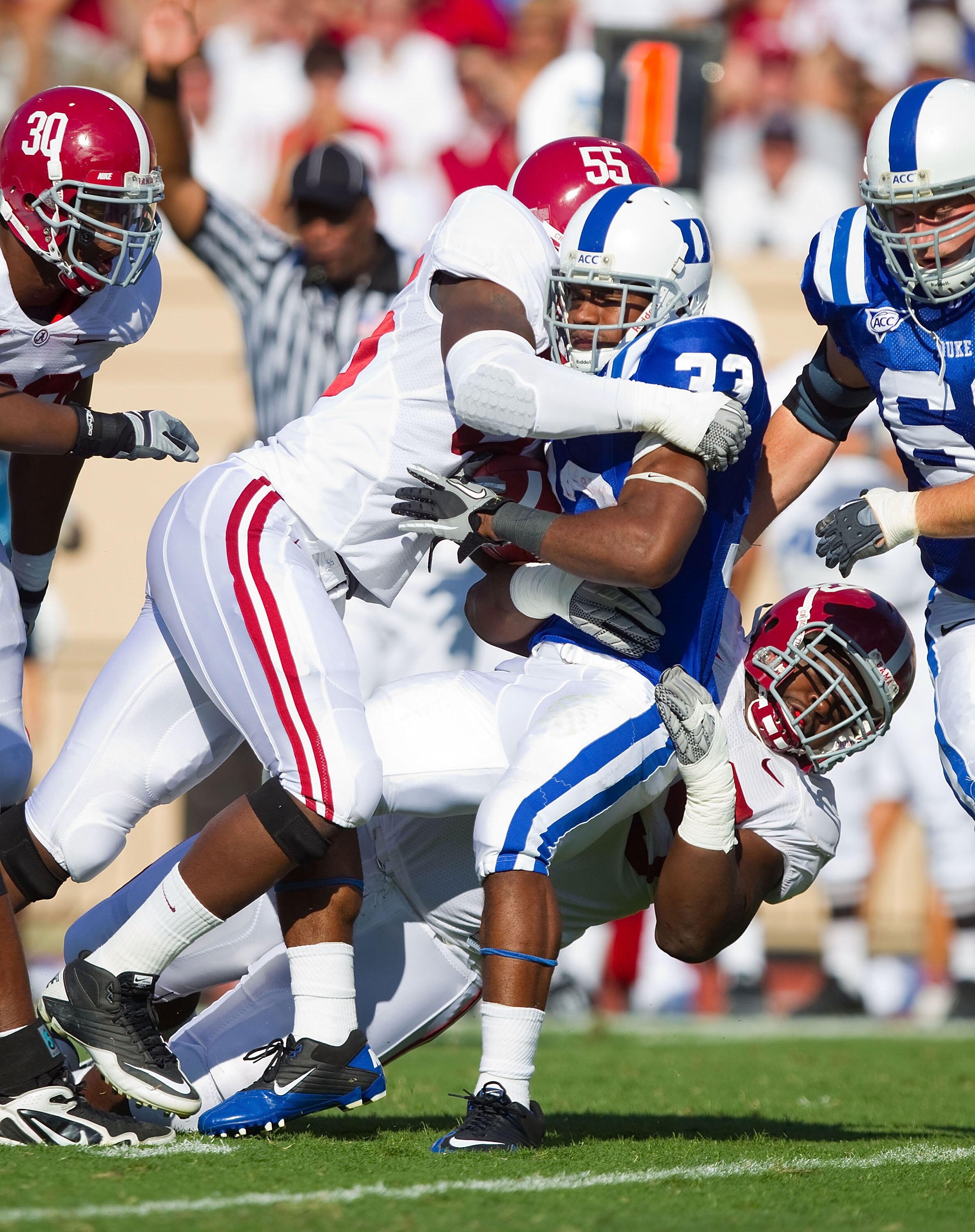 DURHAM, NC - SEPTEMBER 18: Desmond Scott #33 of the Duke Blue Devils is tackled by Chavis Williams #55 of the Alabama Crimson Tide at Wallace Wade Stadium on September 18, 2010 in Durham, North Carolina.  The Crimson Tide defeated the Blue Devils 62-13.