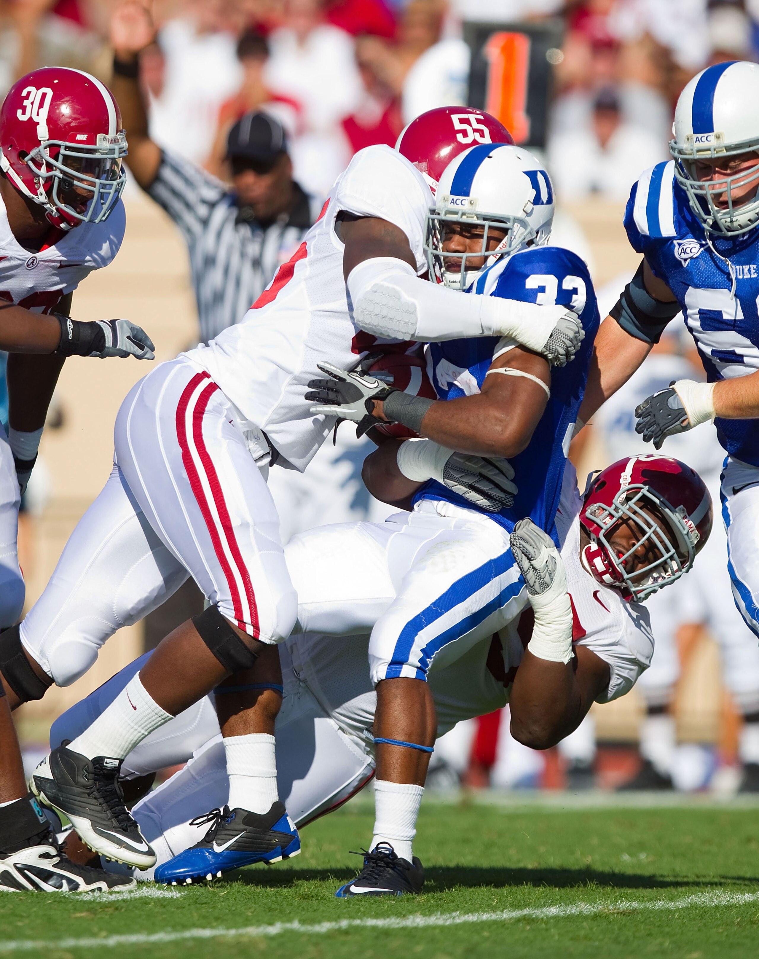 DURHAM, NC - SEPTEMBER 18: Desmond Scott #33 of the Duke Blue Devils is tackled by Chavis Williams #55 of the Alabama Crimson Tide at Wallace Wade Stadium on September 18, 2010 in Durham, North Carolina.  The Crimson Tide defeated the Blue Devils 62-13.