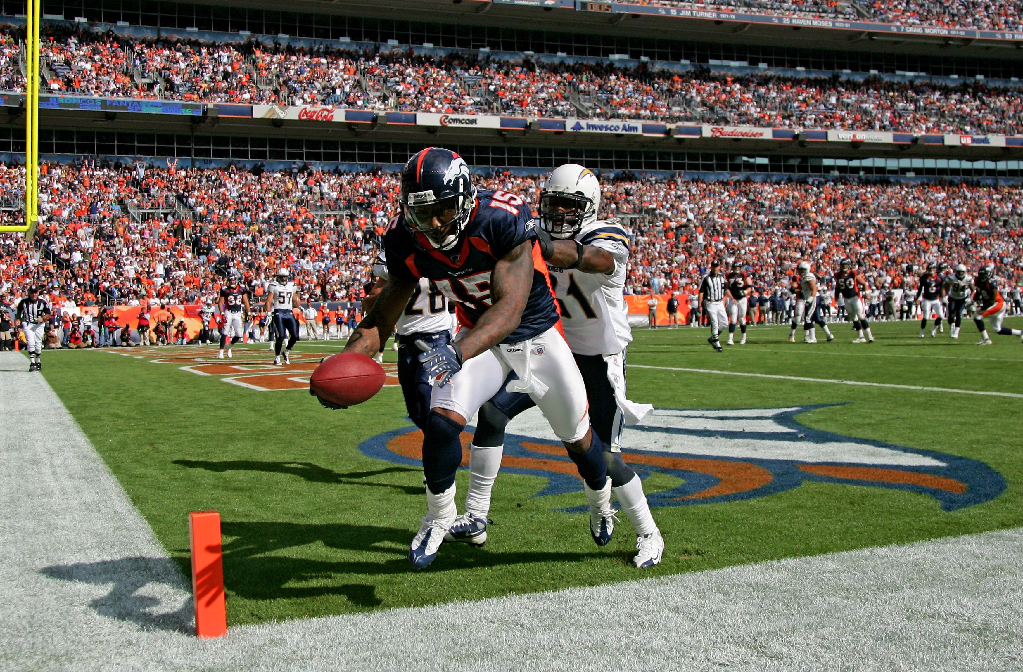 DENVER - SEPTEMBER 14:  Barndon Marshall #15 of the Denver Broncos makes a touchdown reception as Aontonio Cromartie #31 of the San Diego Chargers defends at Invesco Field at Mile High on September 14, 2008 in Denver, Colorado. Marshall's 6 yard reception