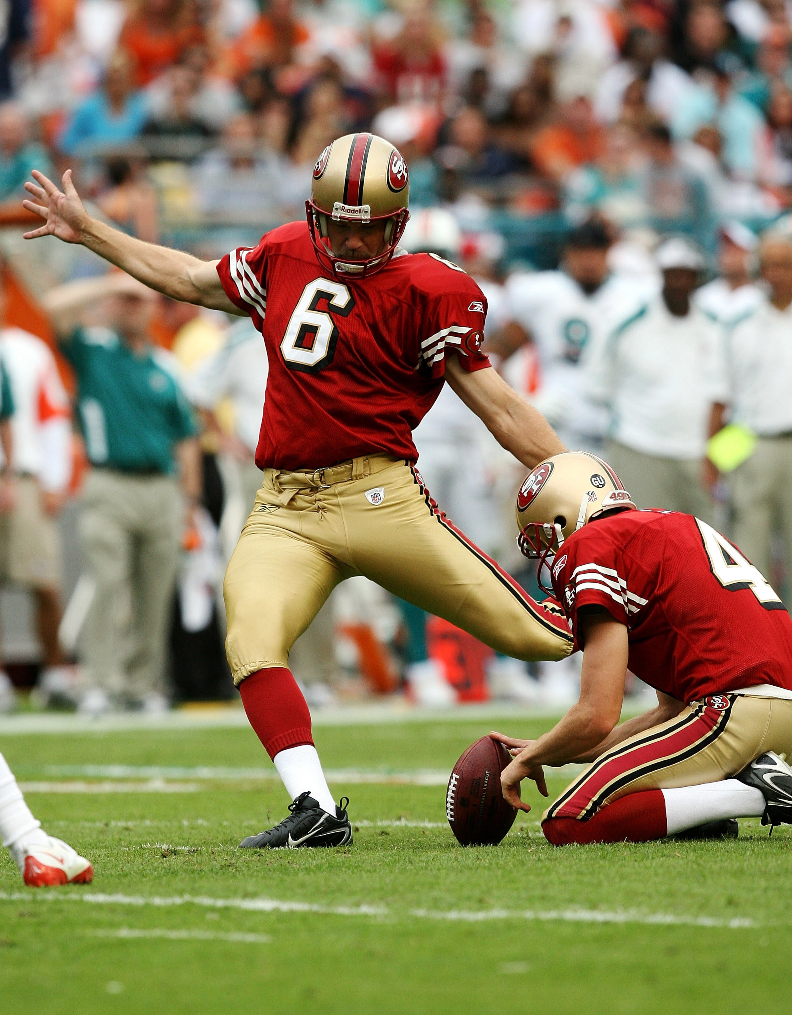 MIAMI - DECEMBER 14: Place kicker Joe Nedney #6 of the San Francisco 49ers kicks a field goal out from under the hold of punter Andy Lee #4 while taking on the Miami Dolphins at Dolphin Stadium on December 14, 2008 in Miami, Florida. The Dolphins defeate MIAMI - DECEMBER 14: Place kicker Joe Nedney #6 of the San Francisco 49ers kicks a field goal out from under the hold of punter Andy Lee #4 while taking on the Miami Dolphins at Dolphin Stadium on December 14, 2008 in Miami, Florida. The Dolphins defeate