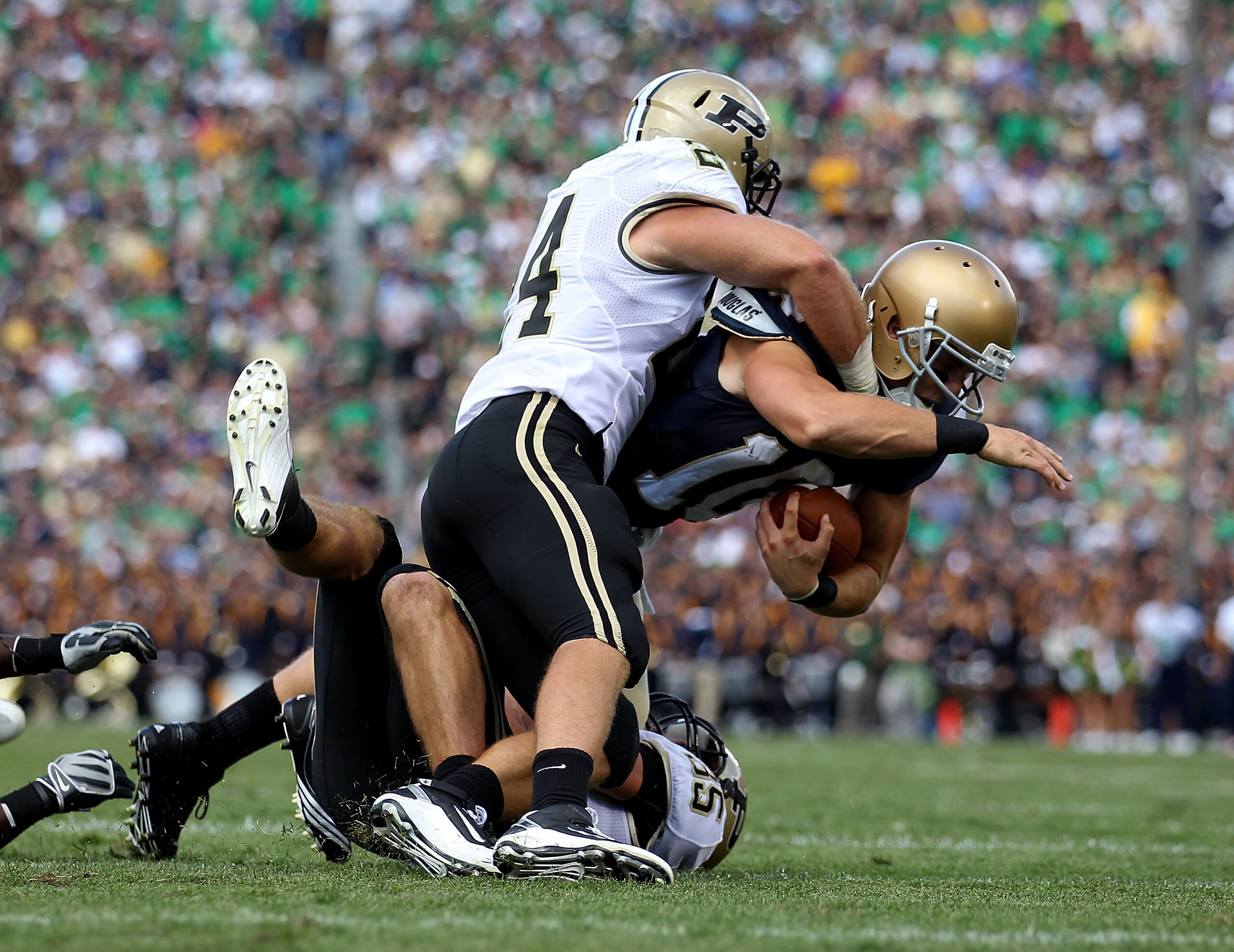SOUTH BEND, IN - SEPTEMBER 04: Daryn Crist #10 of the Notre Dame Fighting Irish is brought down by Jason Werner #24 and Logan Link #35 of the Purdue Boilermakers at Notre Dame Stadium on September 4, 2010 in South Bend, Indiana. Notre Dame defated Purdue SOUTH BEND, IN - SEPTEMBER 04: Daryn Crist #10 of the Notre Dame Fighting Irish is brought down by Jason Werner #24 and Logan Link #35 of the Purdue Boilermakers at Notre Dame Stadium on September 4, 2010 in South Bend, Indiana. Notre Dame defated Purdue