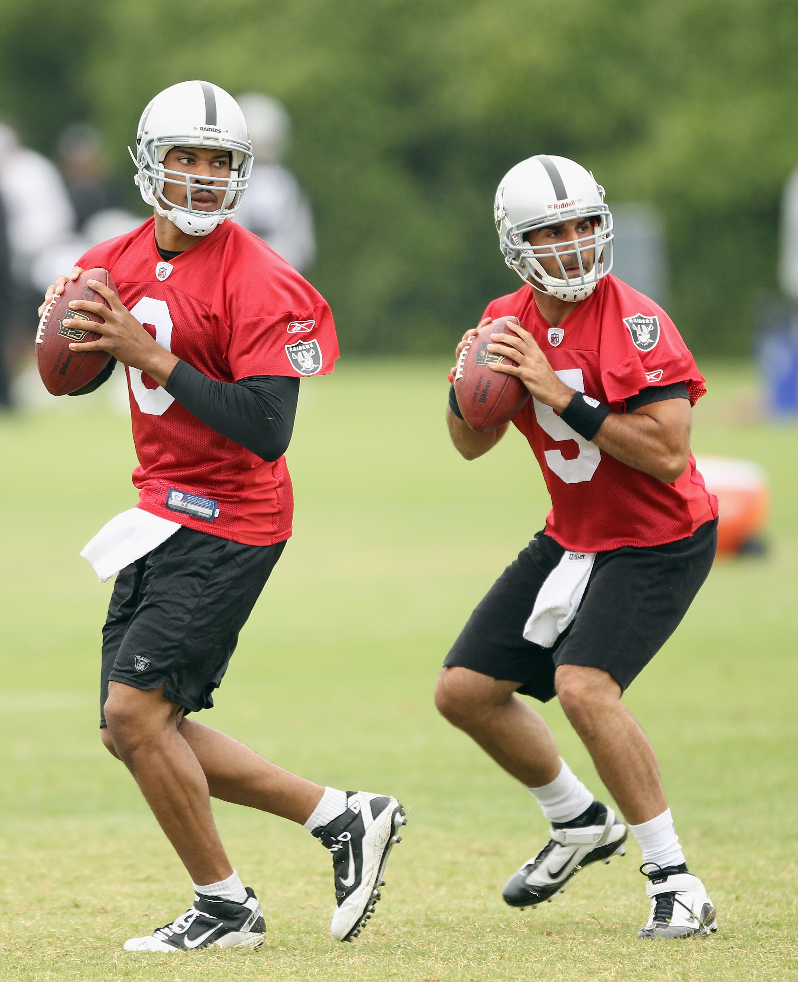 NAPA, CA - AUGUST 01:  Jason Campbell #8 and Bruce Gradkowski #5 of the Oakland Raiders work out during the Raiders training camp at their Napa Valley Training Complex on August 1, 2010 in Napa, California.  (Photo by Ezra Shaw/Getty Images)
