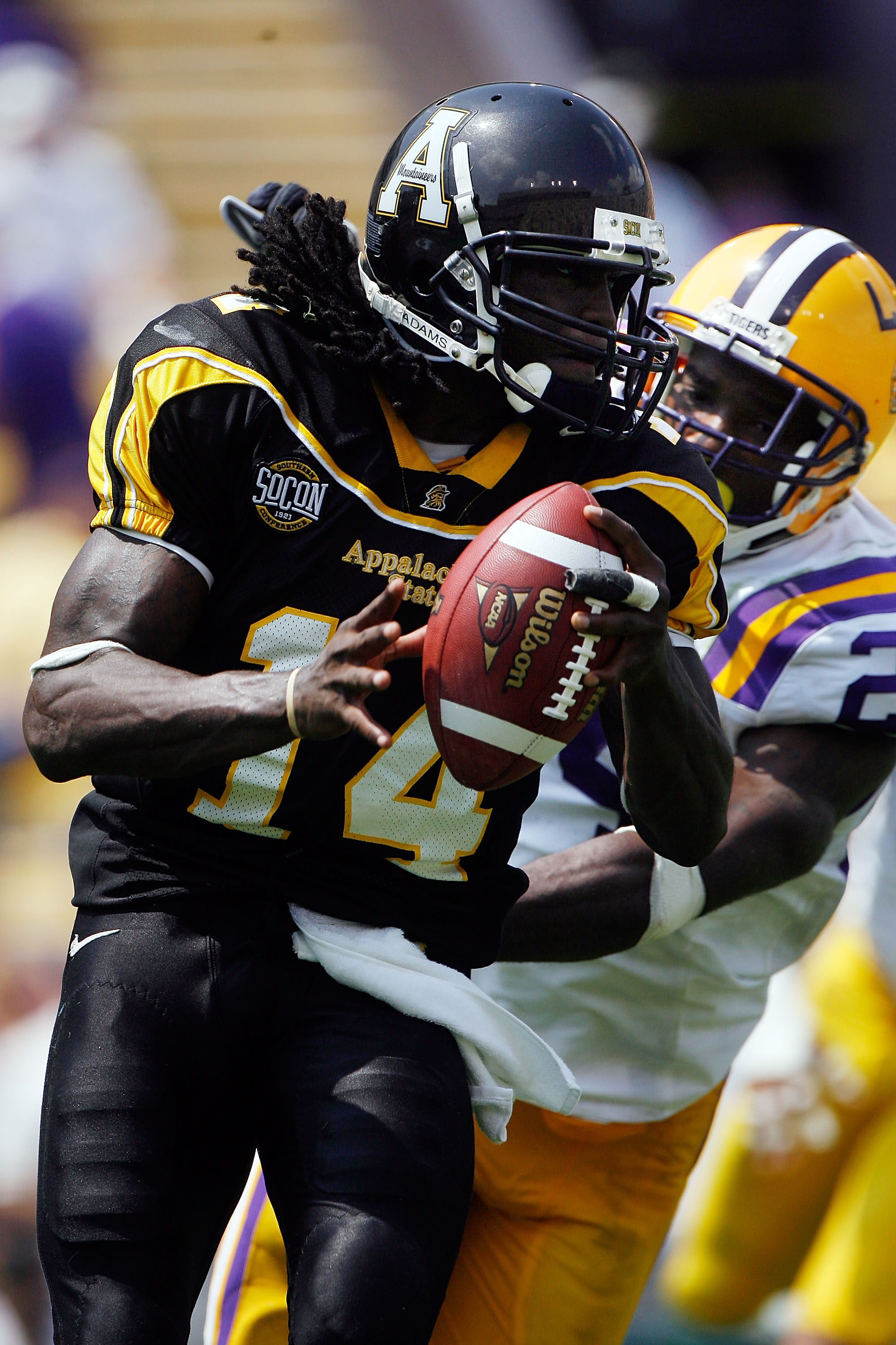 BATON ROUGE, LA - AUGUST 30:  Quarterback Armanti Edwards #14 of the Appalachian State Mountaineers avoids a sack by Harry Coleman #24 of the Louisiana State University Tigers on August 30, 2008 at Tiger Stadium in Baton Rouge, Louisiana.  (Photo by Chris
