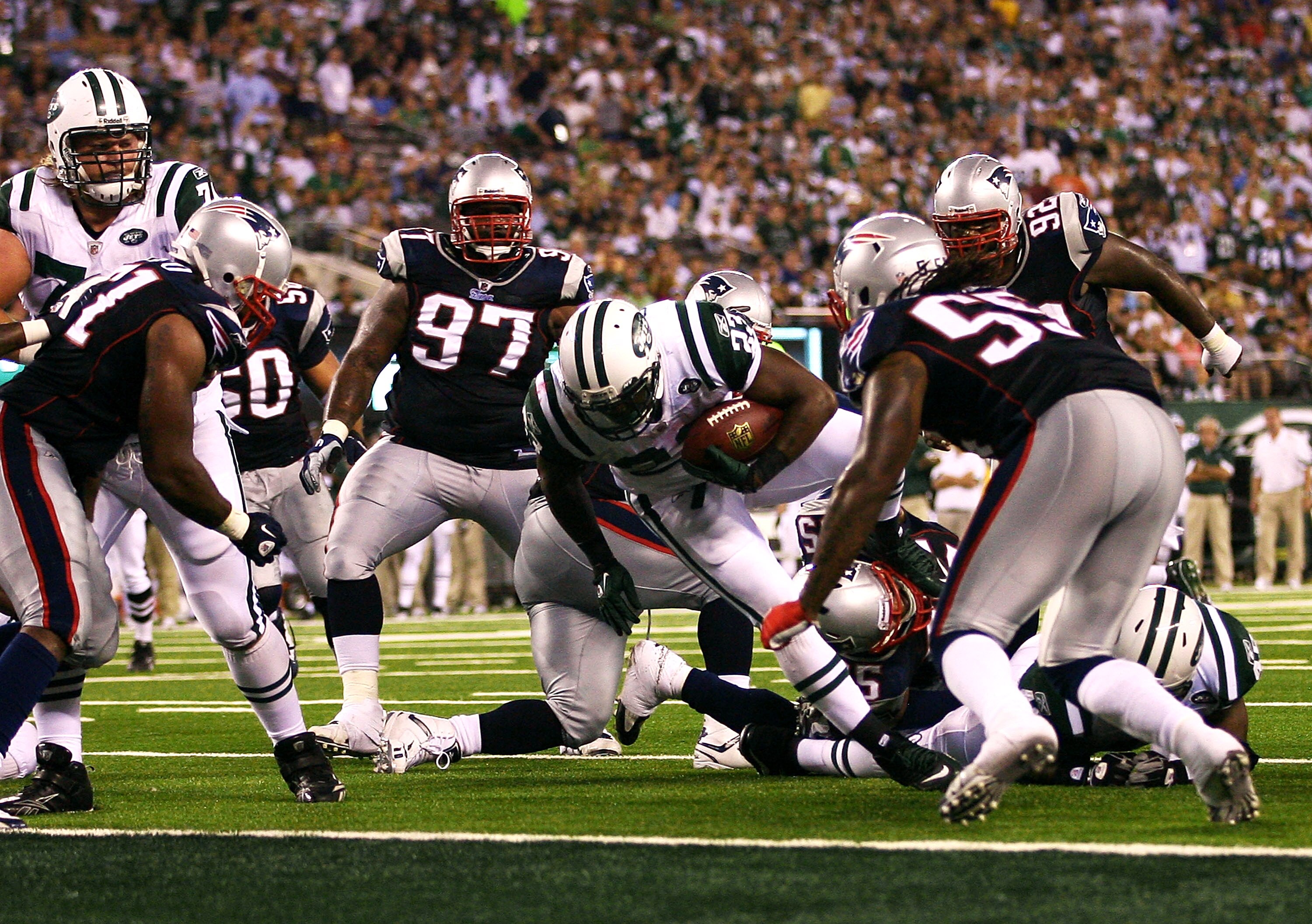 EAST RUTHERFORD, NJ - SEPTEMBER 19: Shonn Green #23 of the New York Jets is held short by the New England Patriots at the New Meadowlands Stadium on September 19, 2010 in East Rutherford, New Jersey. The Jets defeated the Patriots 28 - 14.  (Photo by Andr