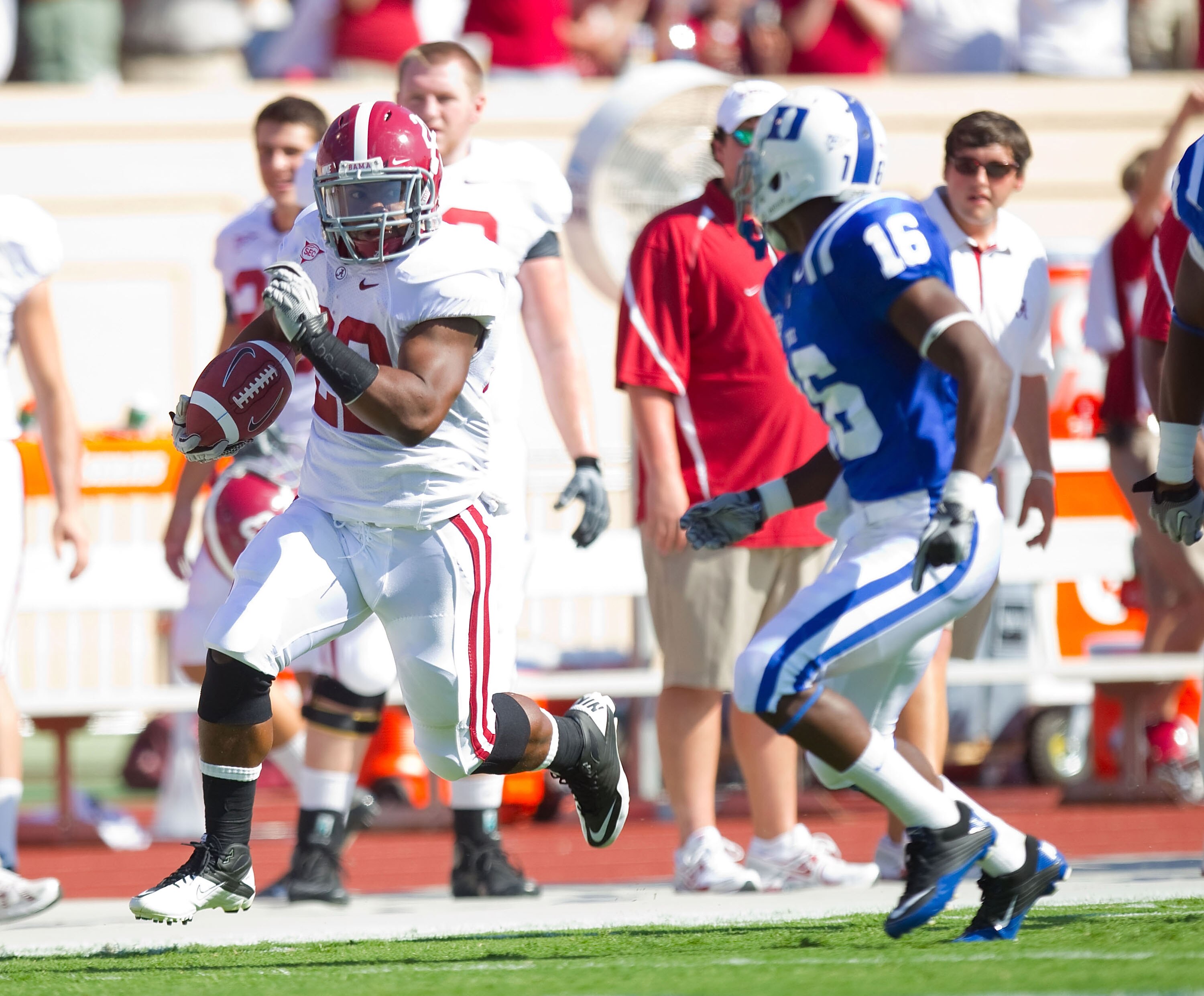 DURHAM, NC - SEPTEMBER 18: Mark Ingram #22 of the Alabama Crimson Tide runs down the sideline away from Chris Rwabukamba #16 of the Duke Blue Devils at Wallace Wade Stadium on September 18, 2010 in Durham, North Carolina. The Crimson Tide defeated the Bl DURHAM, NC - SEPTEMBER 18: Mark Ingram #22 of the Alabama Crimson Tide runs down the sideline away from Chris Rwabukamba #16 of the Duke Blue Devils at Wallace Wade Stadium on September 18, 2010 in Durham, North Carolina. The Crimson Tide defeated the Bl