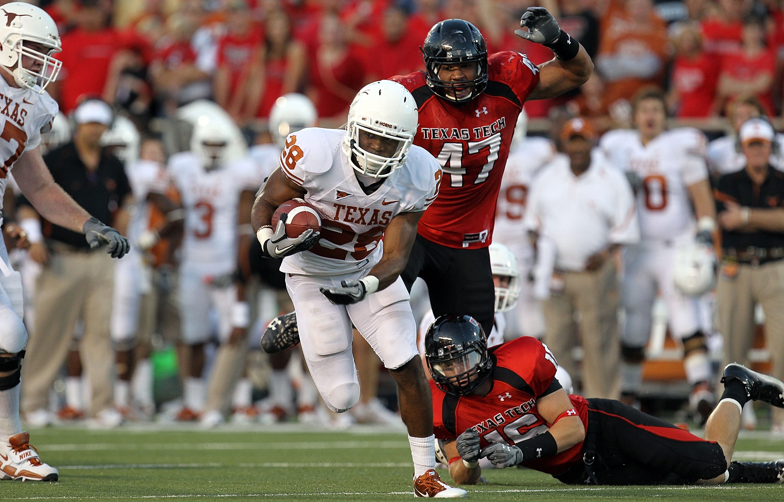 LUBBOCK, TX - SEPTEMBER 18: Running back Foswhitt Whittaker #28 of the Texas Longhorns runs the ball past Cody Davis #16 of the Texas Tech Red Raiders at Jones AT&T Stadium on September 18, 2010 in Lubbock, Texas. (Photo by Ronald Martinez/Getty Images) LUBBOCK, TX - SEPTEMBER 18: Running back Foswhitt Whittaker #28 of the Texas Longhorns runs the ball past Cody Davis #16 of the Texas Tech Red Raiders at Jones AT&T Stadium on September 18, 2010 in Lubbock, Texas. (Photo by Ronald Martinez/Getty Images)