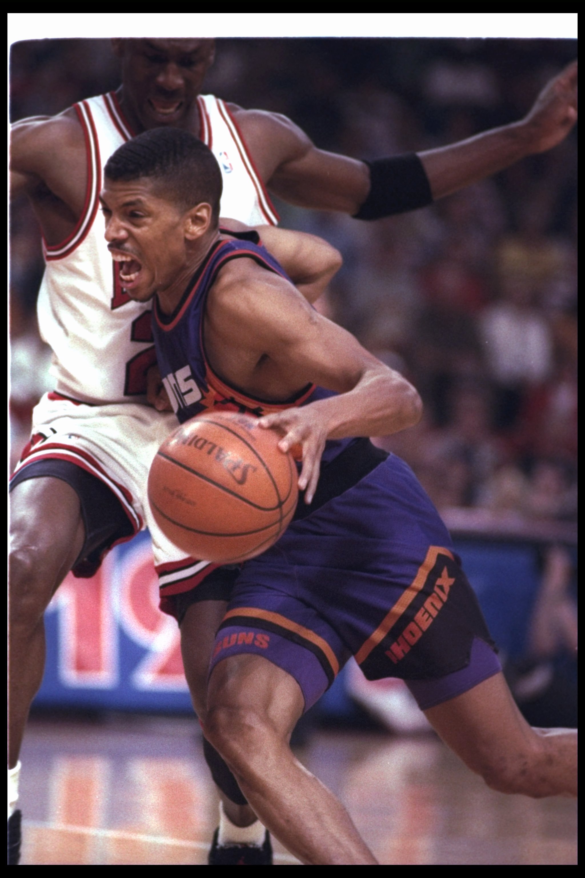18 Jun 1993: Guard Kevin Johnson of the Phoenix Suns moves the ball during a game against the Chicago Bulls at the United Center in Chicago, Illinois. The Suns won the game, 108-98.