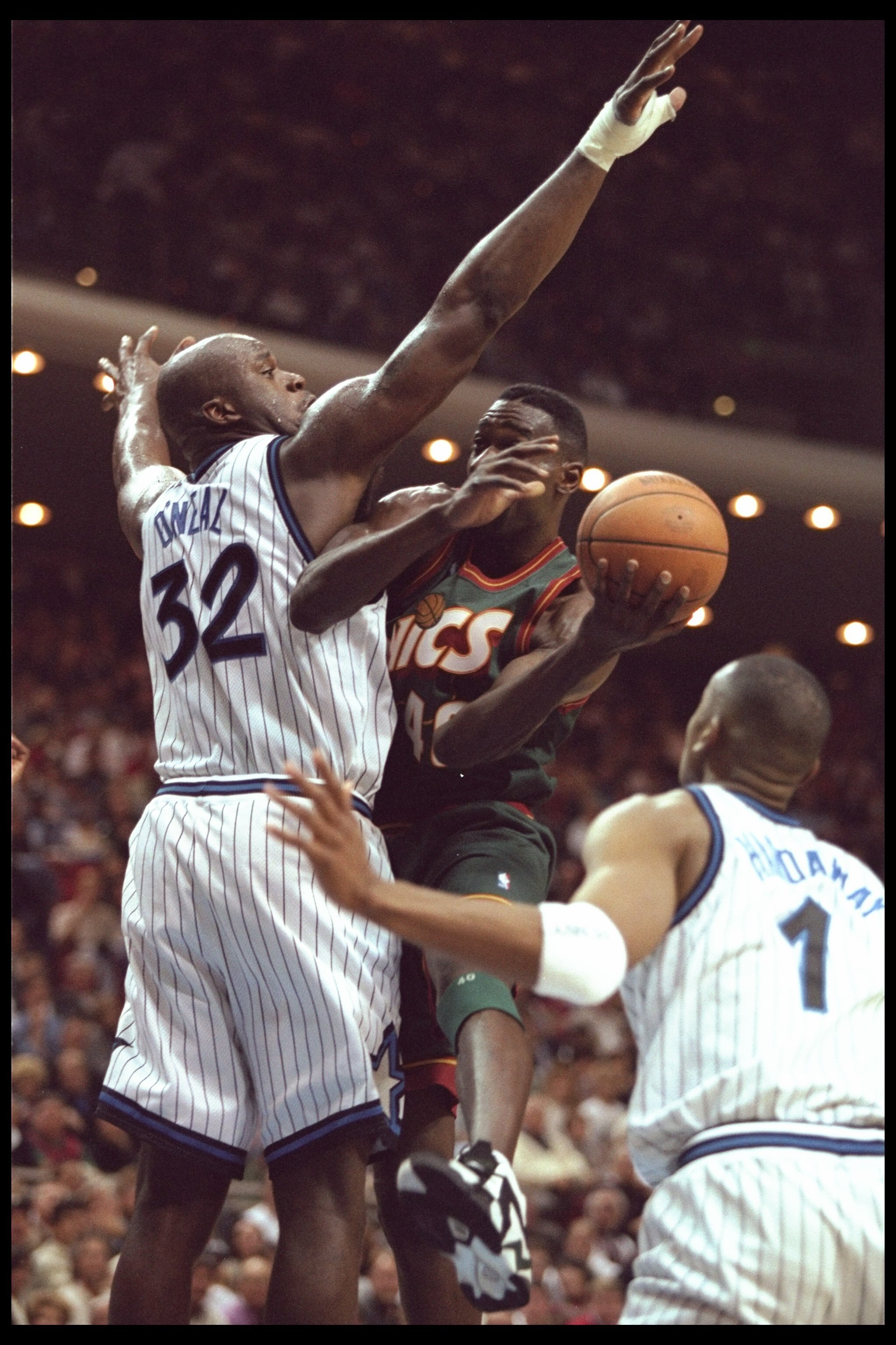 5 Jan 1996:  Forward Shawn Kemp of the Seattle Supersonics goes up for a shot against Orlando Magic center Shaquille O'Neal and guard Penny Hardaway during a game played at the Orlando Arena in Orlando, Florida.  The Magic won the game, 115-93. Mandatory