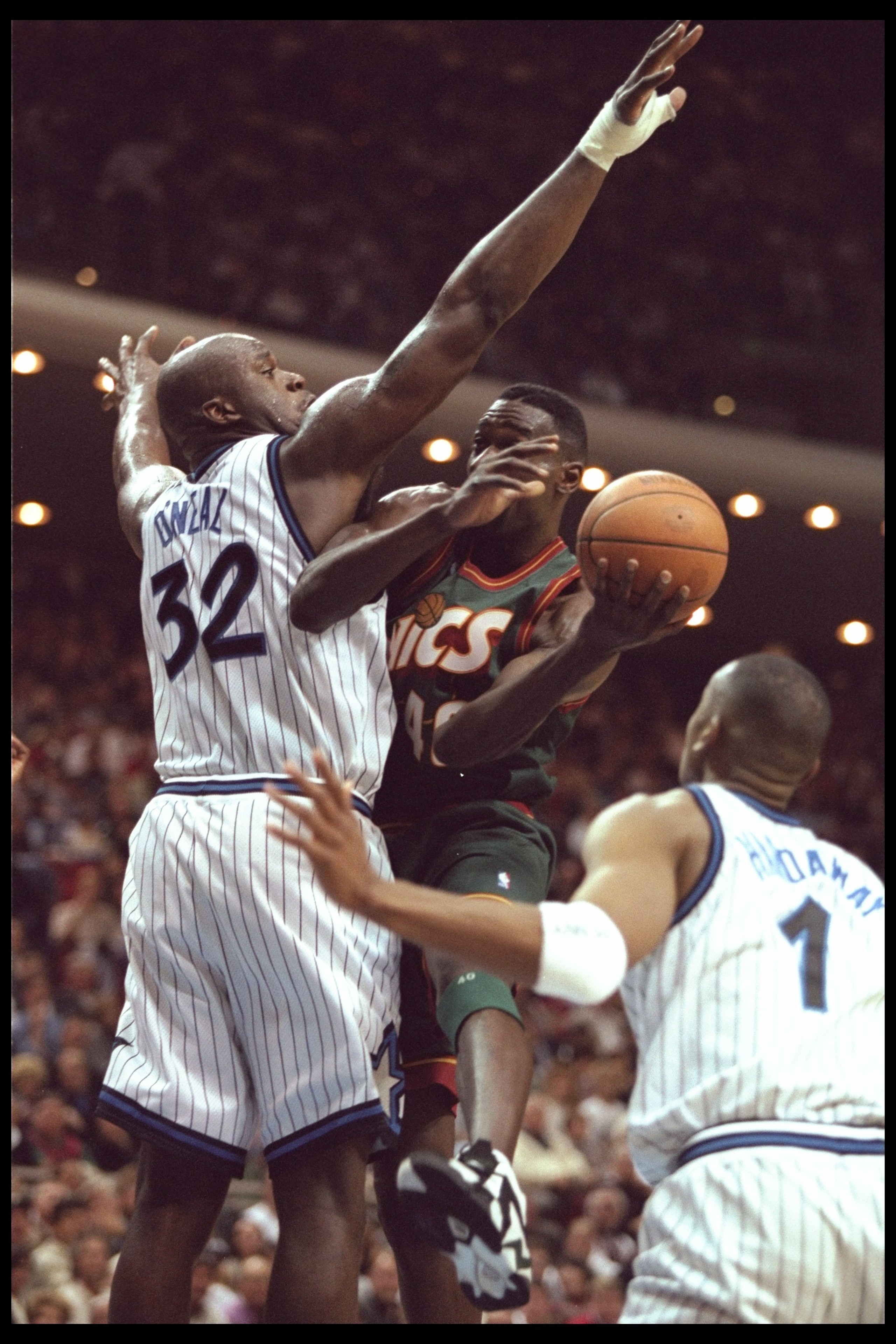 5 Jan 1996:  Forward Shawn Kemp of the Seattle Supersonics goes up for a shot against Orlando Magic center Shaquille O'Neal and guard Penny Hardaway during a game played at the Orlando Arena in Orlando, Florida.  The Magic won the game, 115-93. Mandatory