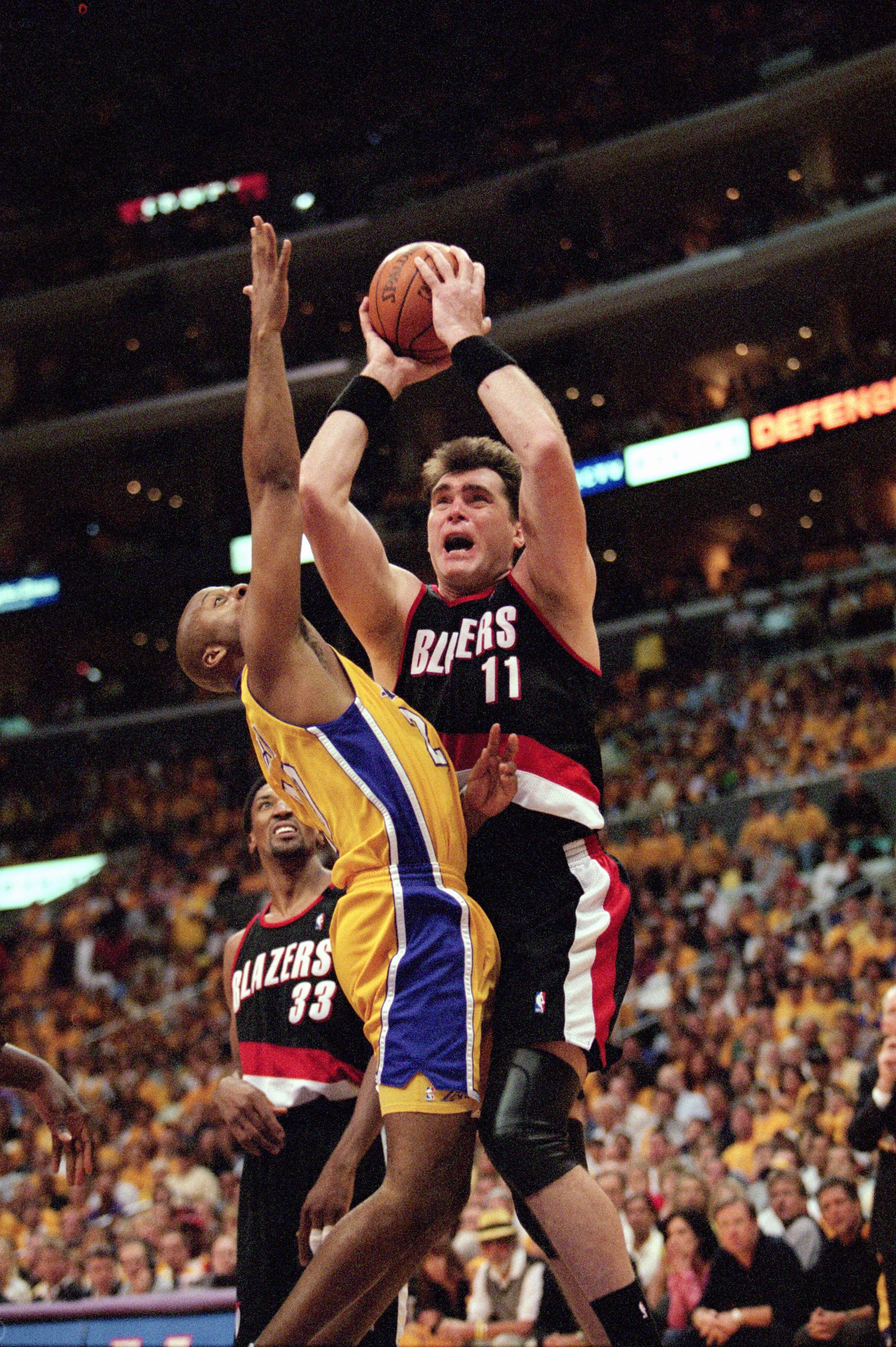 LOS ANGELES - JUNE 4:  Center Arvydas Sabonis #11 of the Portland Trail Blazers puts up a shot pressured by Brian Shaw #20 of the Los Angeles Lakers during Game 7 of the Western Conference Finals at Staples Center on June 4, 2000 in Los Angeles, Californi