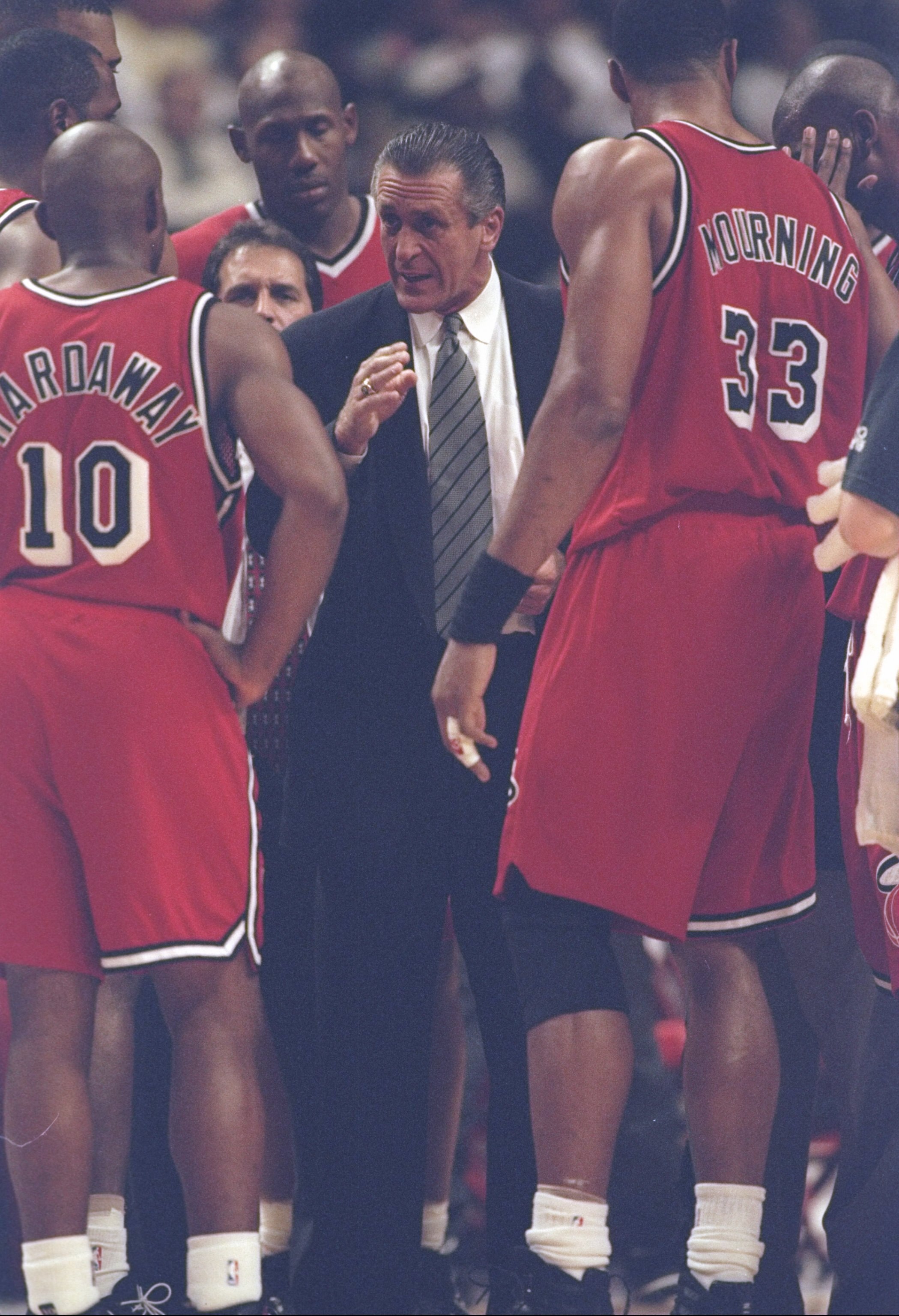 20 May 1997: Center Alonzo Mourning and guard Tim Hardaway listen to coach Pat Riley of the Miami Heat during a game against the Chicago Bulls at the United Center in Chicago, Illinois. The Bulls won the game 84-77.