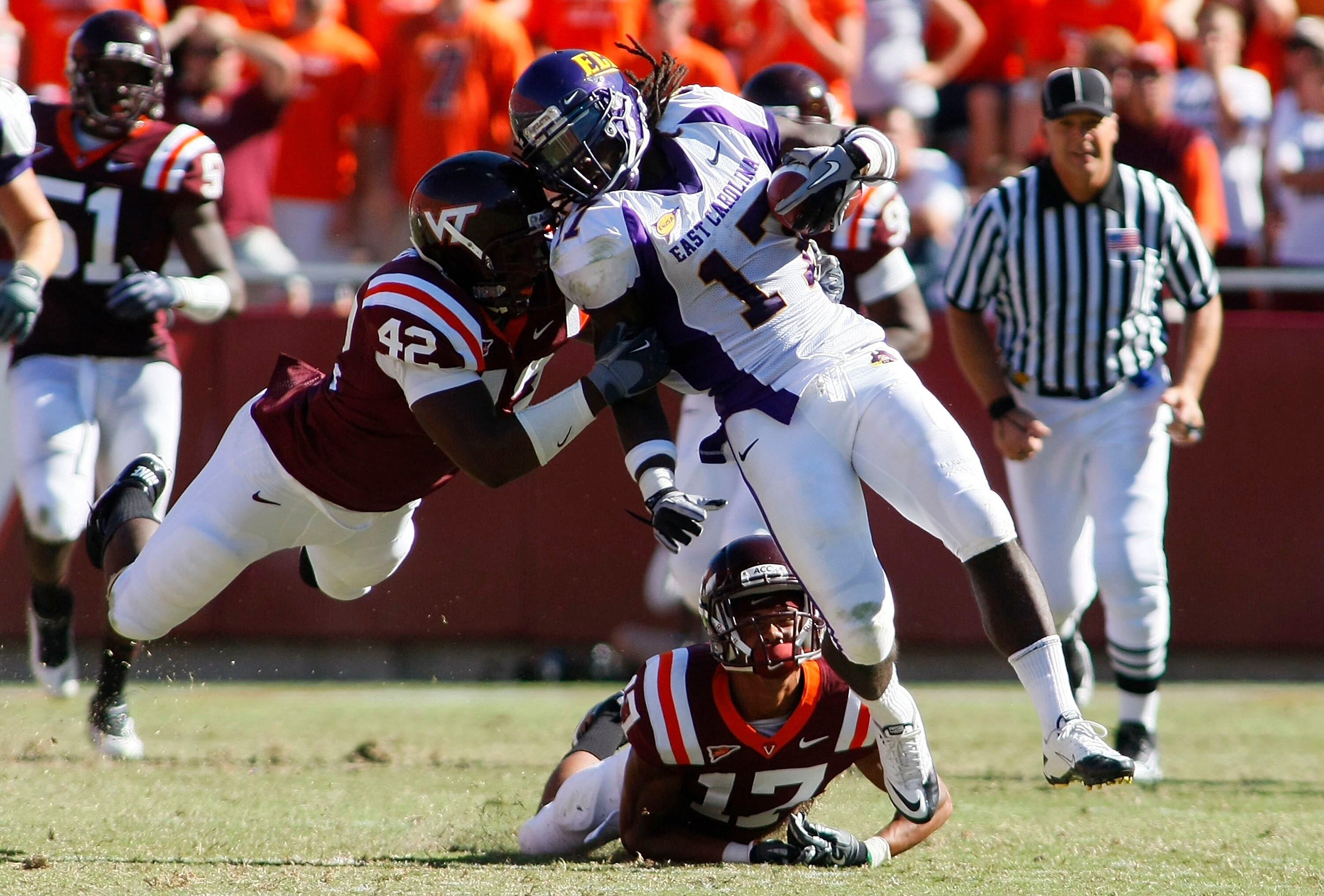 BLACKSBURG, VA - SEPTEMBER 18:  Defensive end J.R. Collins #42 and  cornerback Kyle Fuller #17 of the Virginia Tech Hokies tackle wide receiver Dwayne Harris #17 of the East Carolina Pirates at Lane Stadium on September 18, 2010 in Blacksburg, Virginia.