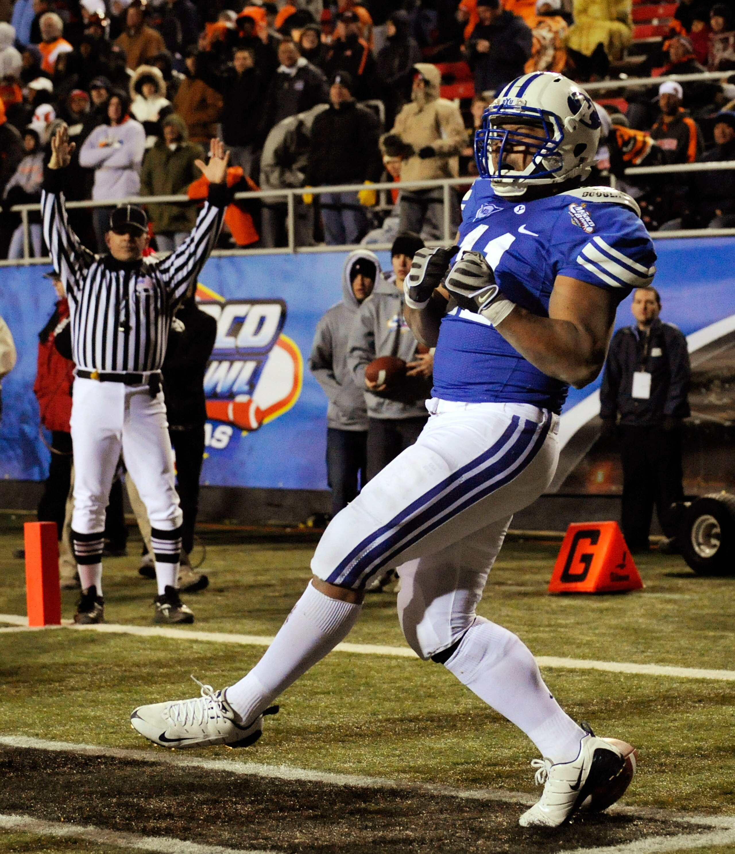LAS VEGAS - DECEMBER 22:  Manase Tonga #11 of the Brigham Young University Cougars celebrates as he scores a touchdown against the Oregon State Beavers in the fourth quarter of the MAACO Las Vegas Bowl at Sam Boyd Stadium December 22, 2009 in Las Vegas, N