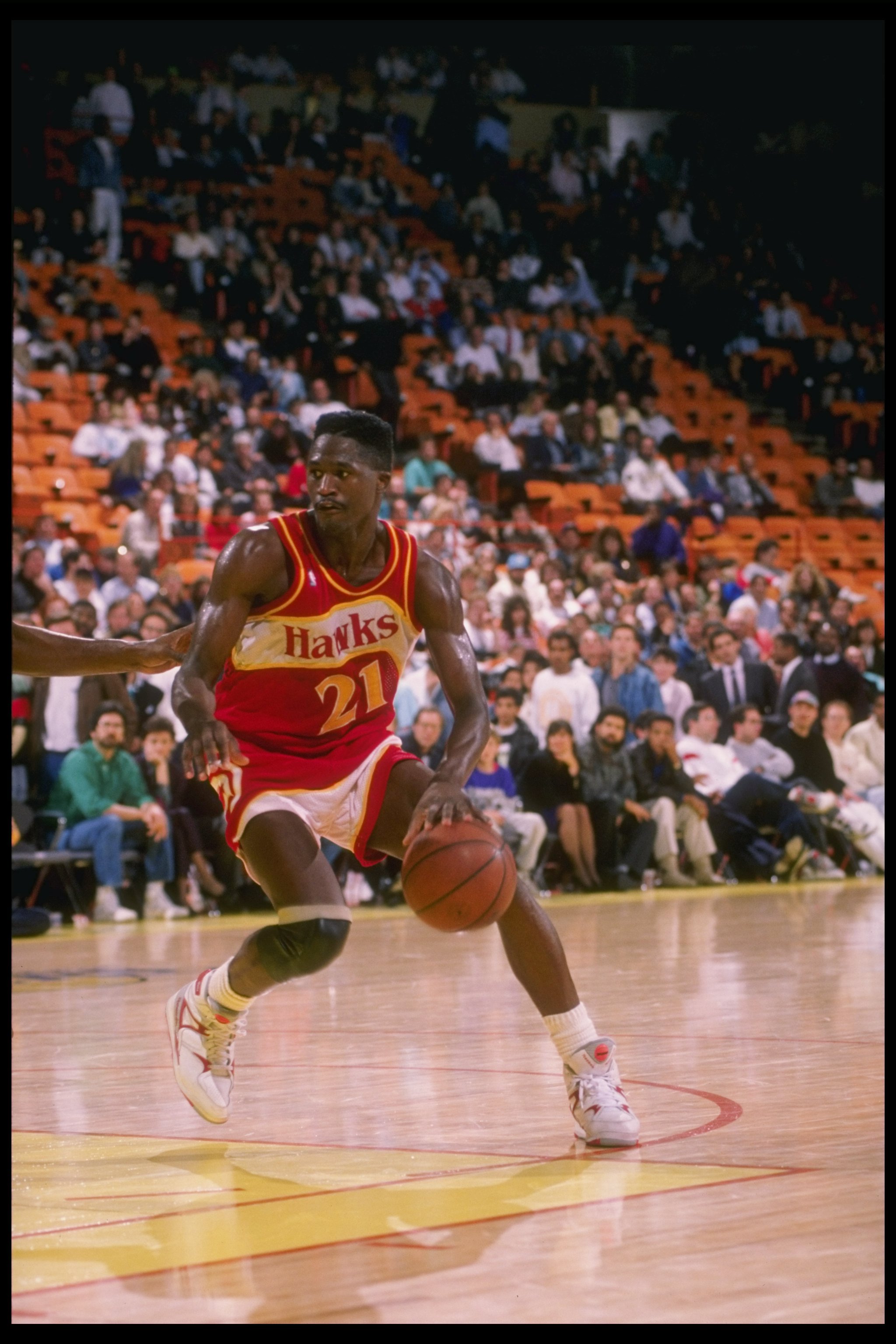 Forward Dominique Wilkins of the Atlanta Hawks dribbles down the court during a game.