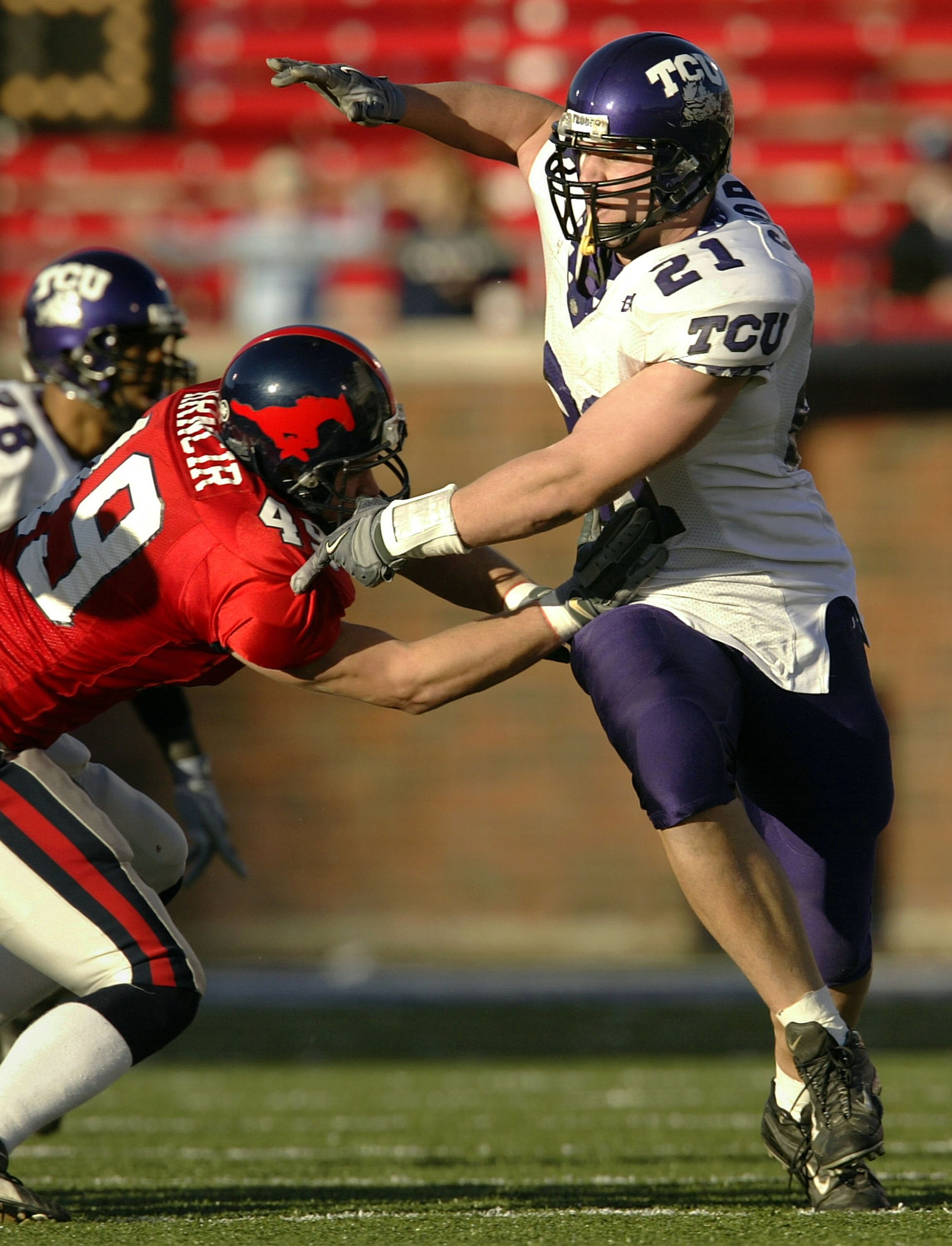 DALLAS - NOVEMBER 29:  Defensive end Bo Schobel #21 of the Texas Christian University Horned Frogs works his way around tight end Trent Hrncir #49 of the Southern Methodist University in the third quarter November 29, 2003 at Gerald J. Ford Stadium in Dal
