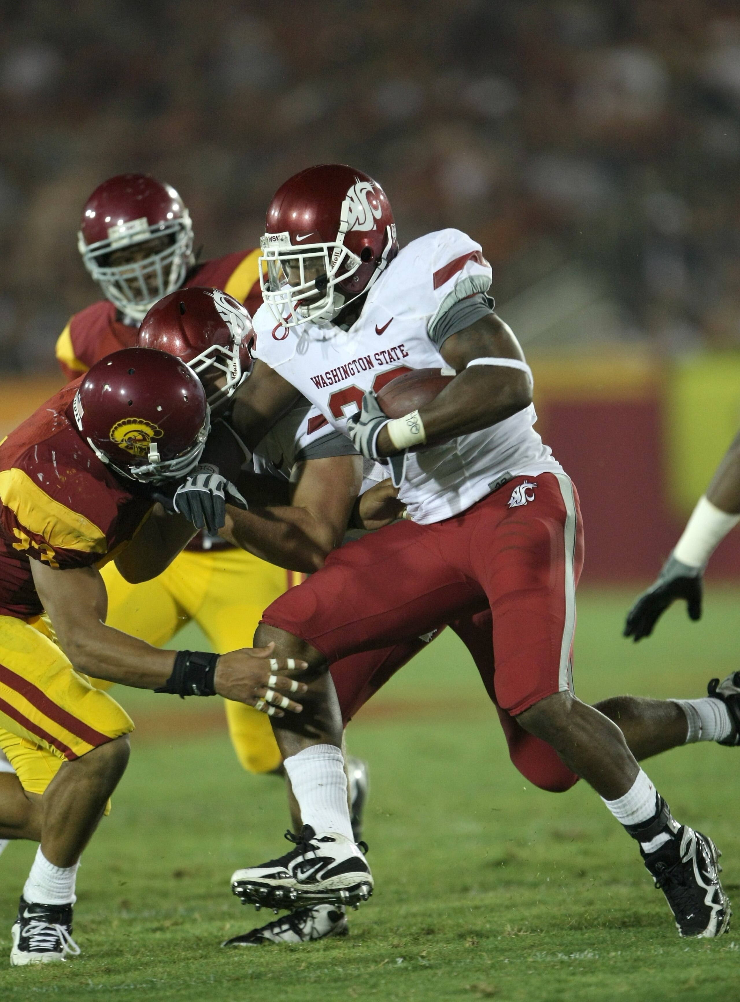 LOS ANGELES, CA - SEPTEMBER 26:  Running back Marcus Richmond #20 of the Washington State Cougars carries the ball against the USC Trojans on September 23, 2009 at the Los Angeles Coliseum in Los Angeles, California.  USC won 27-6.  (Photo by Stephen Dunn