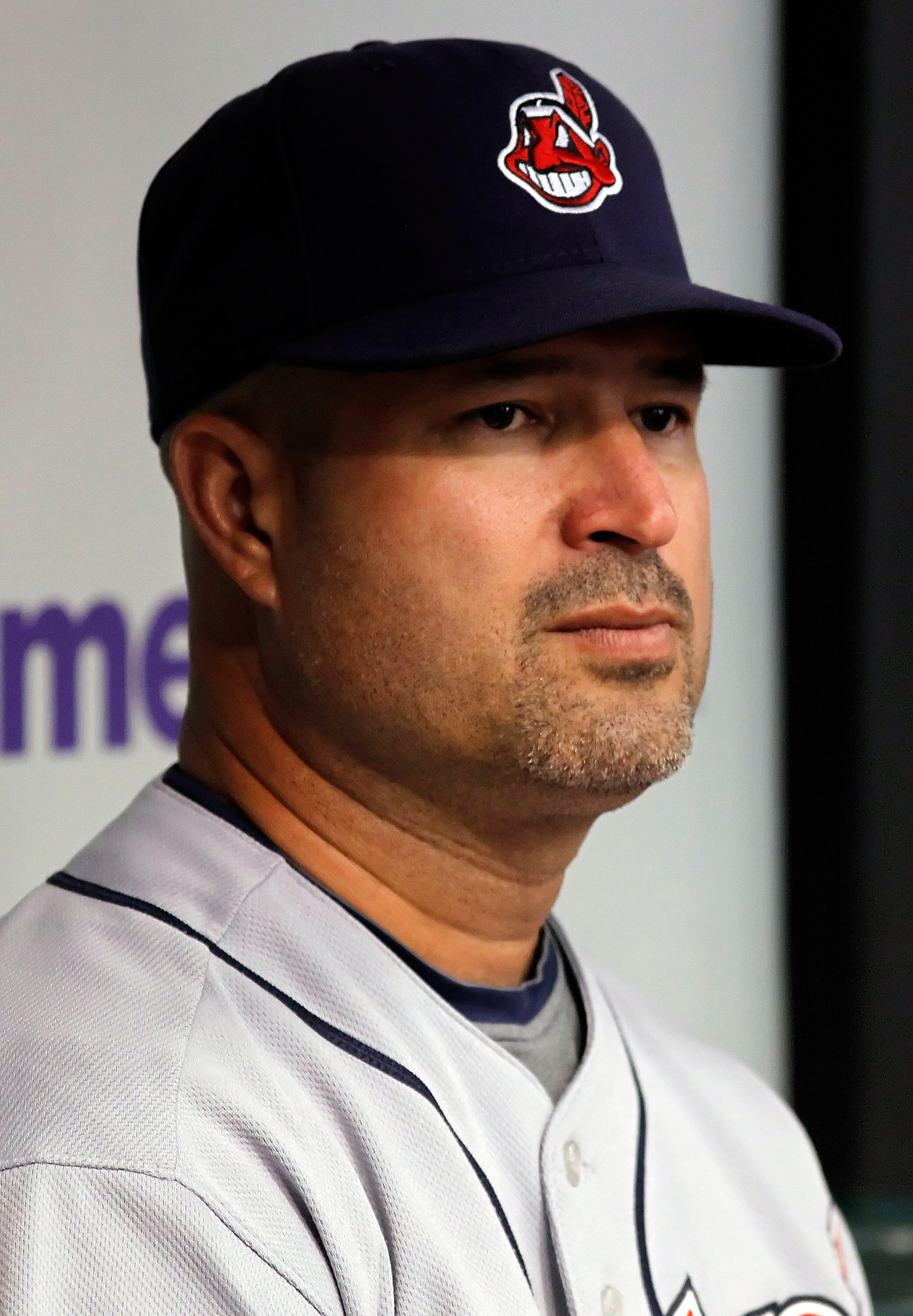 ST. PETERSBURG - JULY 11:  Manager Manny Acta #11 of the Cleveland Indians watches his team from the dugout against the Tampa Bay Rays at Tropicana Field on July 11, 2010 in St. Petersburg, Florida.  (Photo by J. Meric/Getty Images)