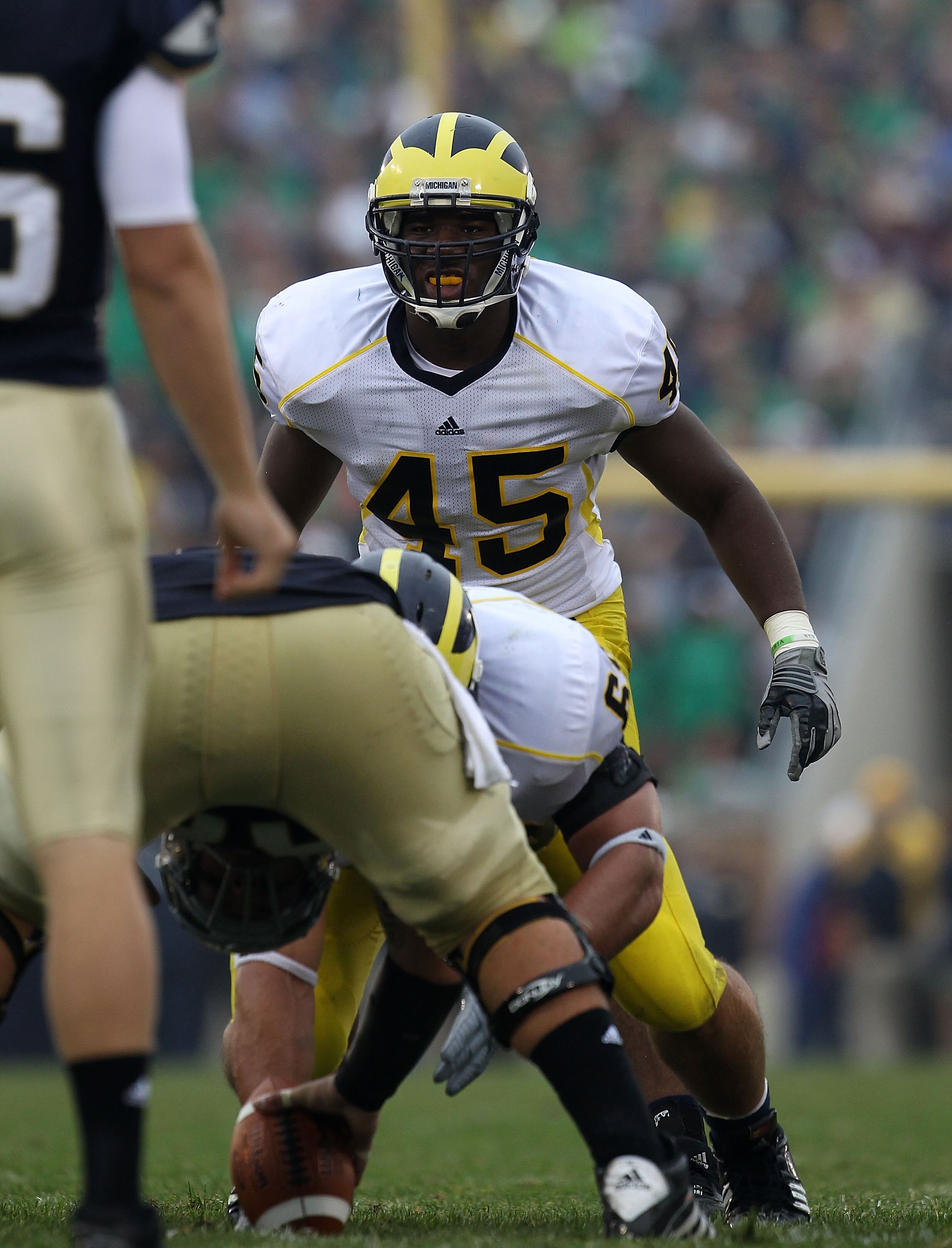 SOUTH BEND, IN - SEPTEMBER 11: Obi Ezeh #45 of the Michigan Wolverines awaits the start of play against the Notre Dame Fighting Irish at Notre Dame Stadium on September 11, 2010 in South Bend, Indiana. Michigan defeated Notre Dame 28-24.  (Photo by Jonath