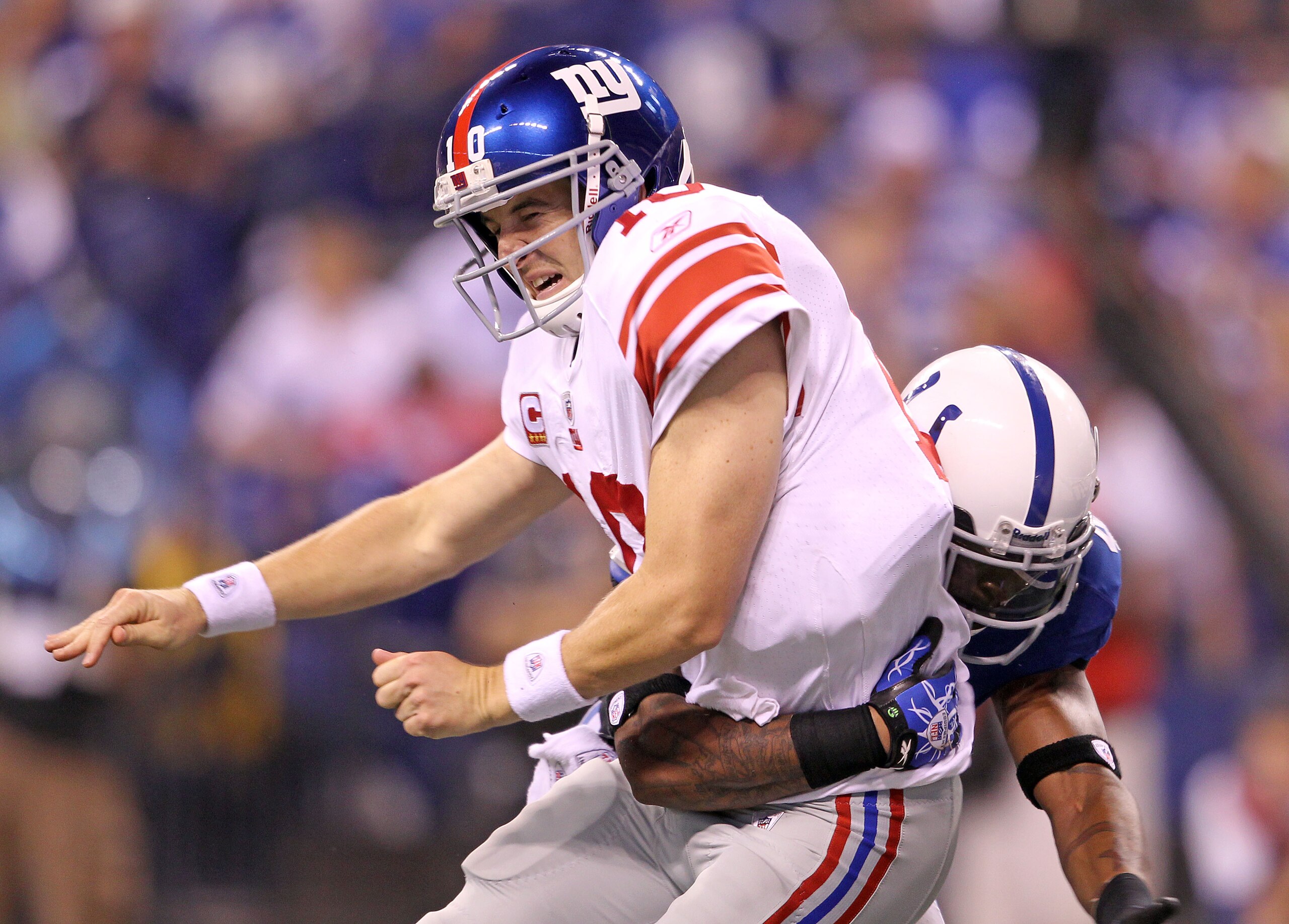 INDIANAPOLIS - SEPTEMBER 19:  Eli Manning #10 of the New York Giants is hit by Antoine Bethea #41 of the Indianapolis Colts during the Colts 38-14 win at Lucas Oil Stadium on September 19, 2010 in Indianapolis, Indiana.  (Photo by Andy Lyons/Getty Images)