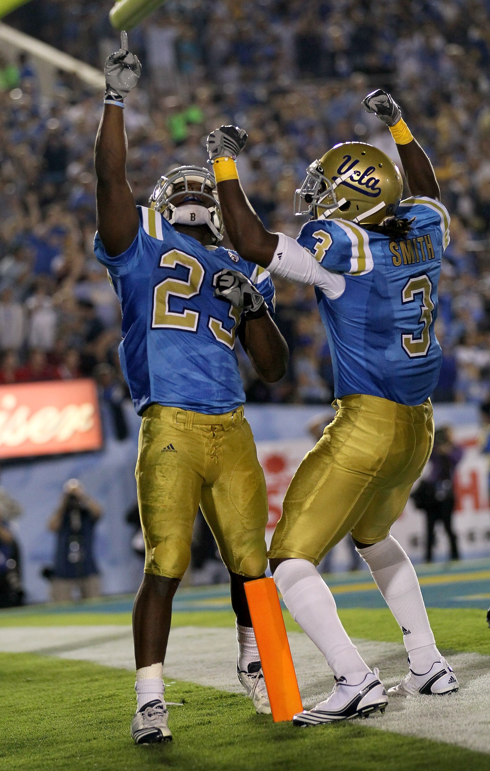 PASADENA, CA - SEPTEMBER 18:  Running back Johnathan Franklin #23 and wide receiver Josh Smith #3 of the UCLA Bruins celebrate Franklin's  touchdown against the Houston Cougars in the second quarter at the Rose Bowl on September 18, 2010 in Pasadena, Cali