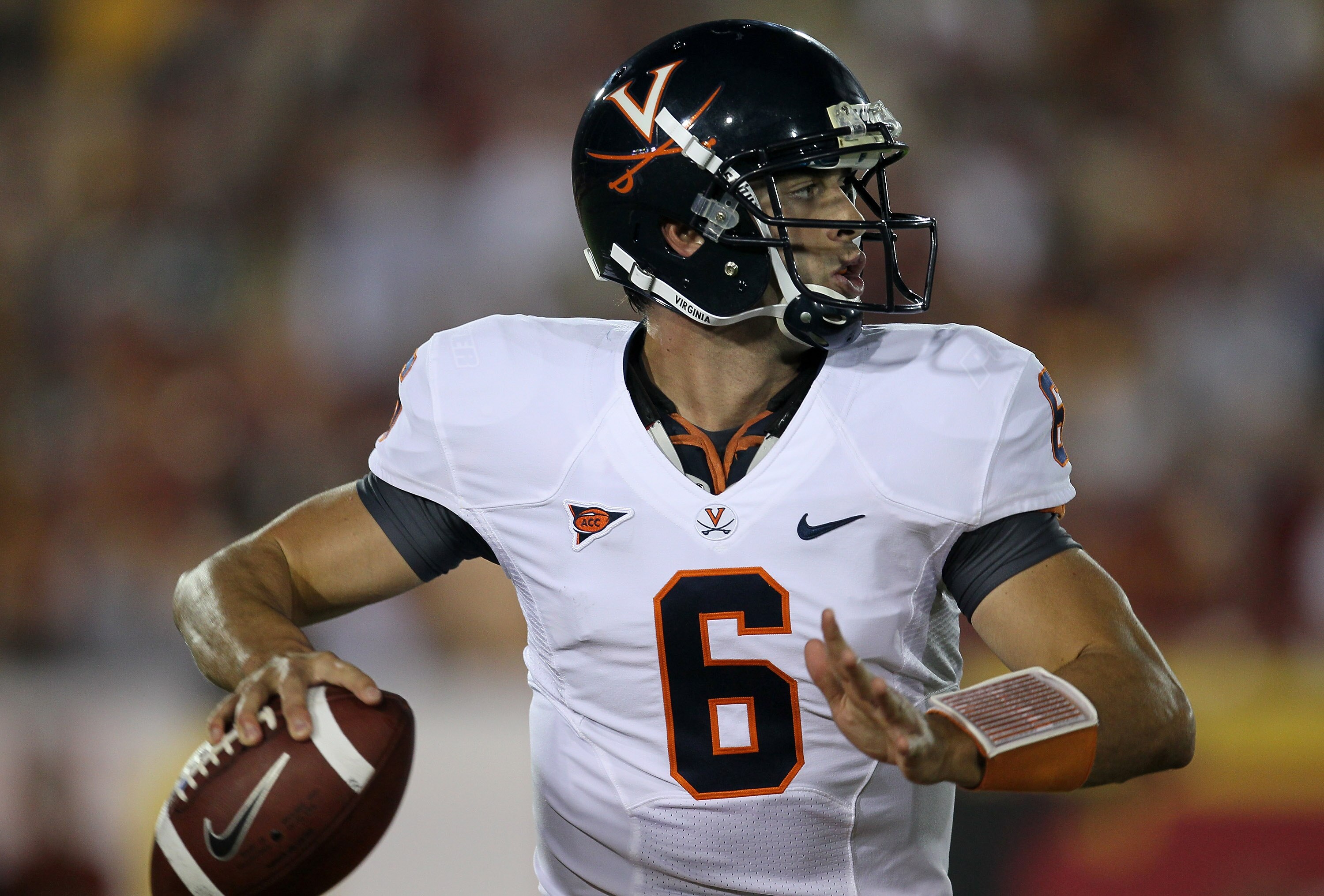 LOS ANGELES, CA - SEPTEMBER 11:  Quarterback Marc Verica #6 of the Virginia Cavaliers throws a pass against the USC Trojans at Los Angeles Memorial Coliseum on September 11, 2010 in Los Angeles, California. USC won 17-14.  (Photo by Stephen Dunn/Getty Ima