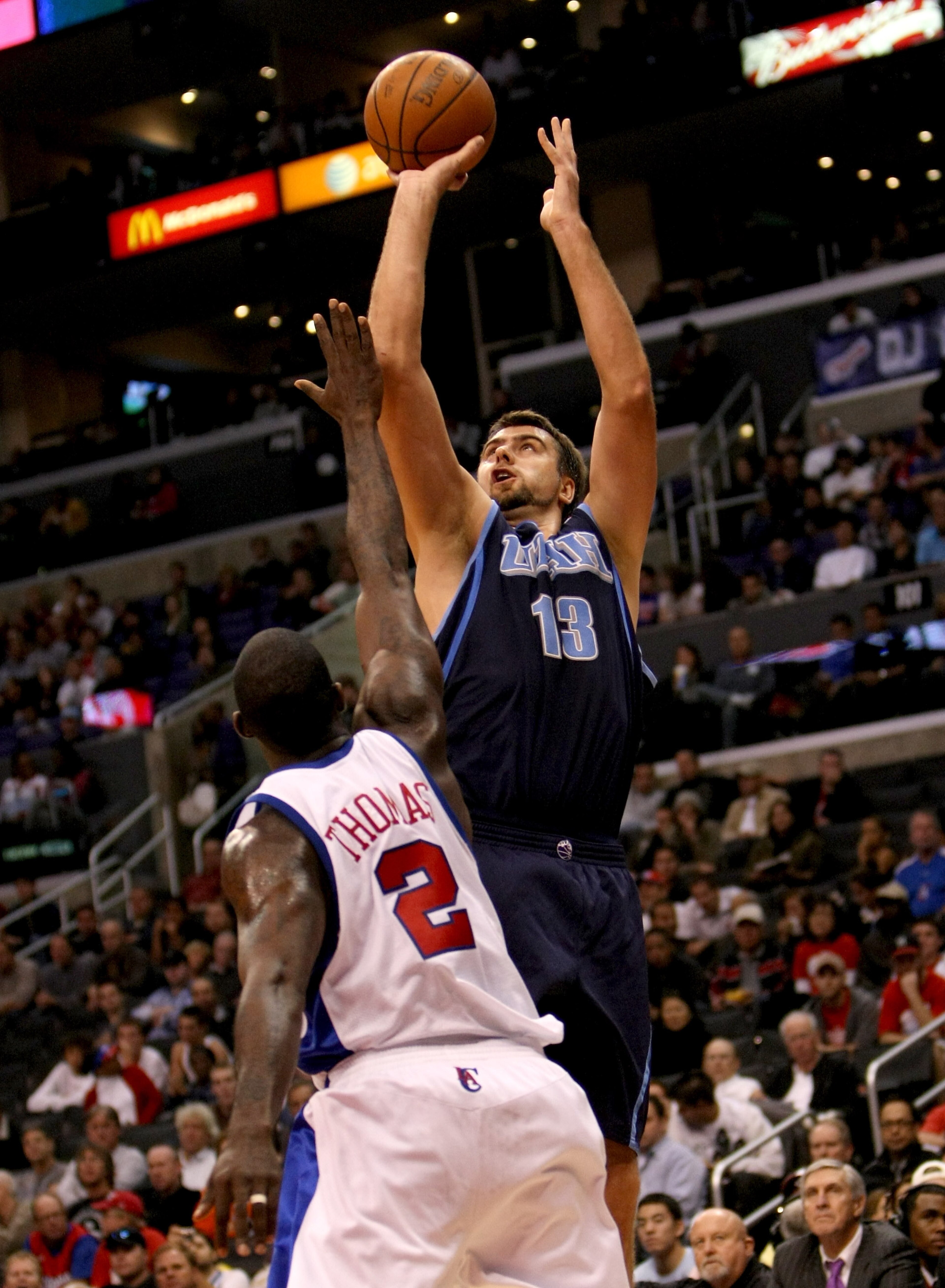 LOS ANGELES - NOVEMBER 3:  Mehmet Okur #13 of the Utah Jazz shoots over Tim Thomas #2 of the Los Angeles Clippers on November 3, 2008 at Staples Center in Los Angeles, California. The Jazz won 89-73.  NOTE TO USER: User expressly acknowledges and agrees t