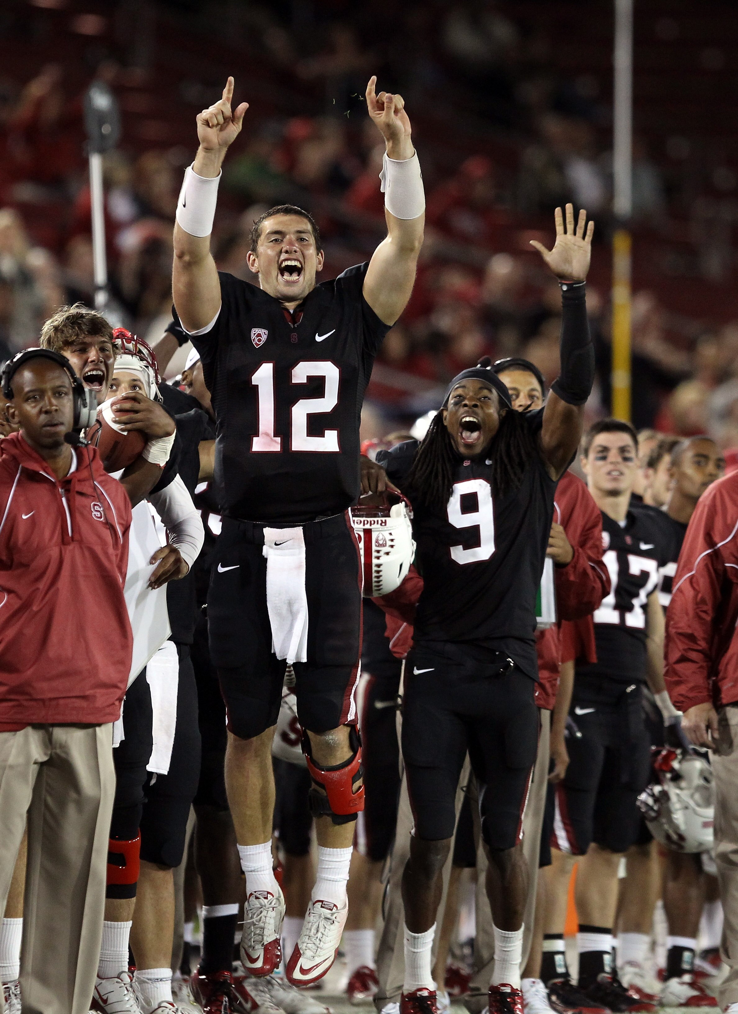 PALO ALTO, CA - SEPTEMBER 18:  Andrew Luck #12 and Richard Sherman #9 of the Stanford Cardinal celebrate from the sidelines after Stanford scored a touchdown to go up 67-24 in the fourth quarter of their game against the Wake Forest Demon Deacons at Stanf