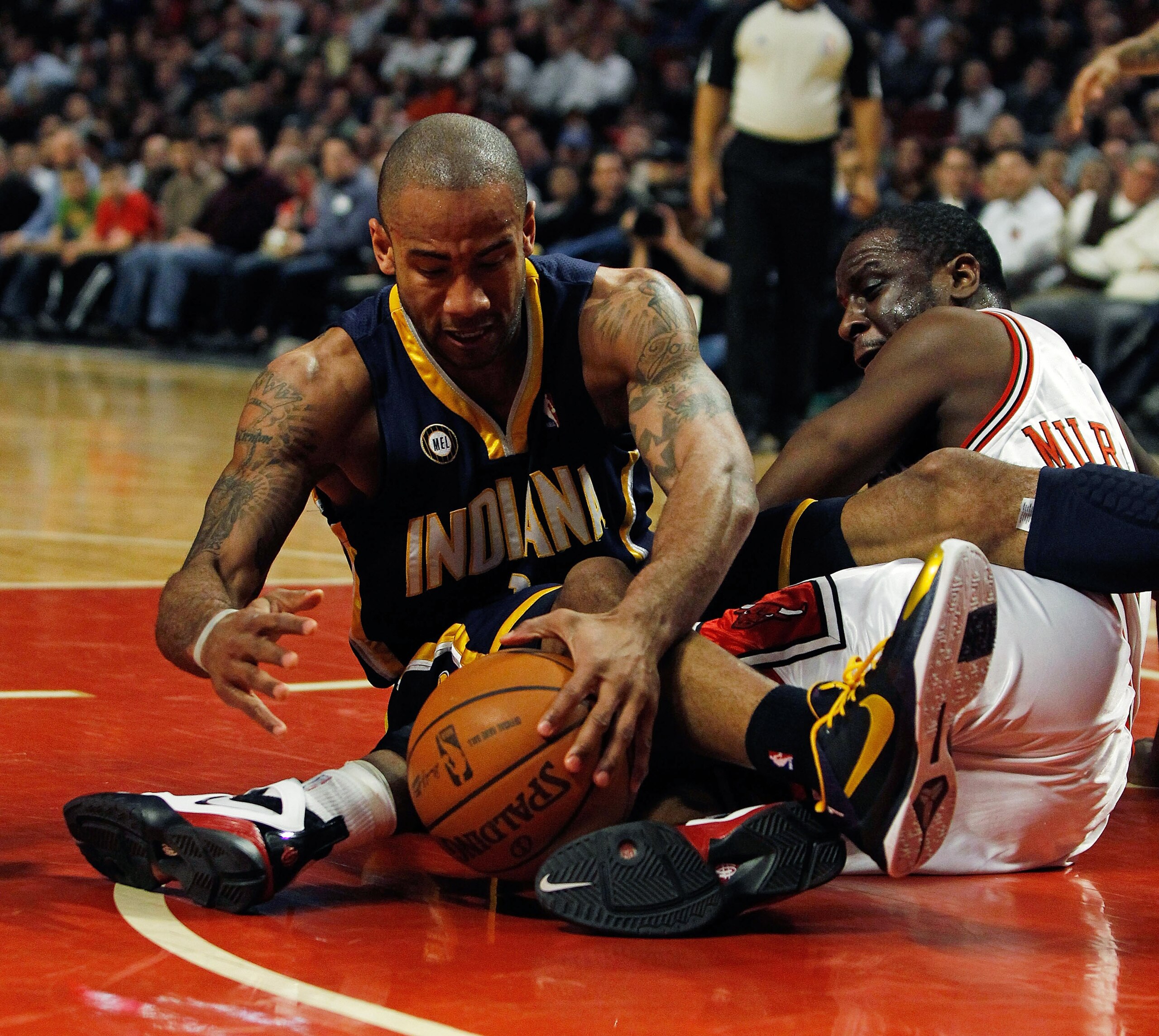 CHICAGO - FEBRUARY 24: Dahntay Jones #1 of the Indiana Pacers battles for a loose ball with Ronald Murray #6 of the Chicago Bulls at the United Center on February 24, 2010 in Chicago, Illinois. NOTE TO USER: User expressly acknowledges and agrees that, by