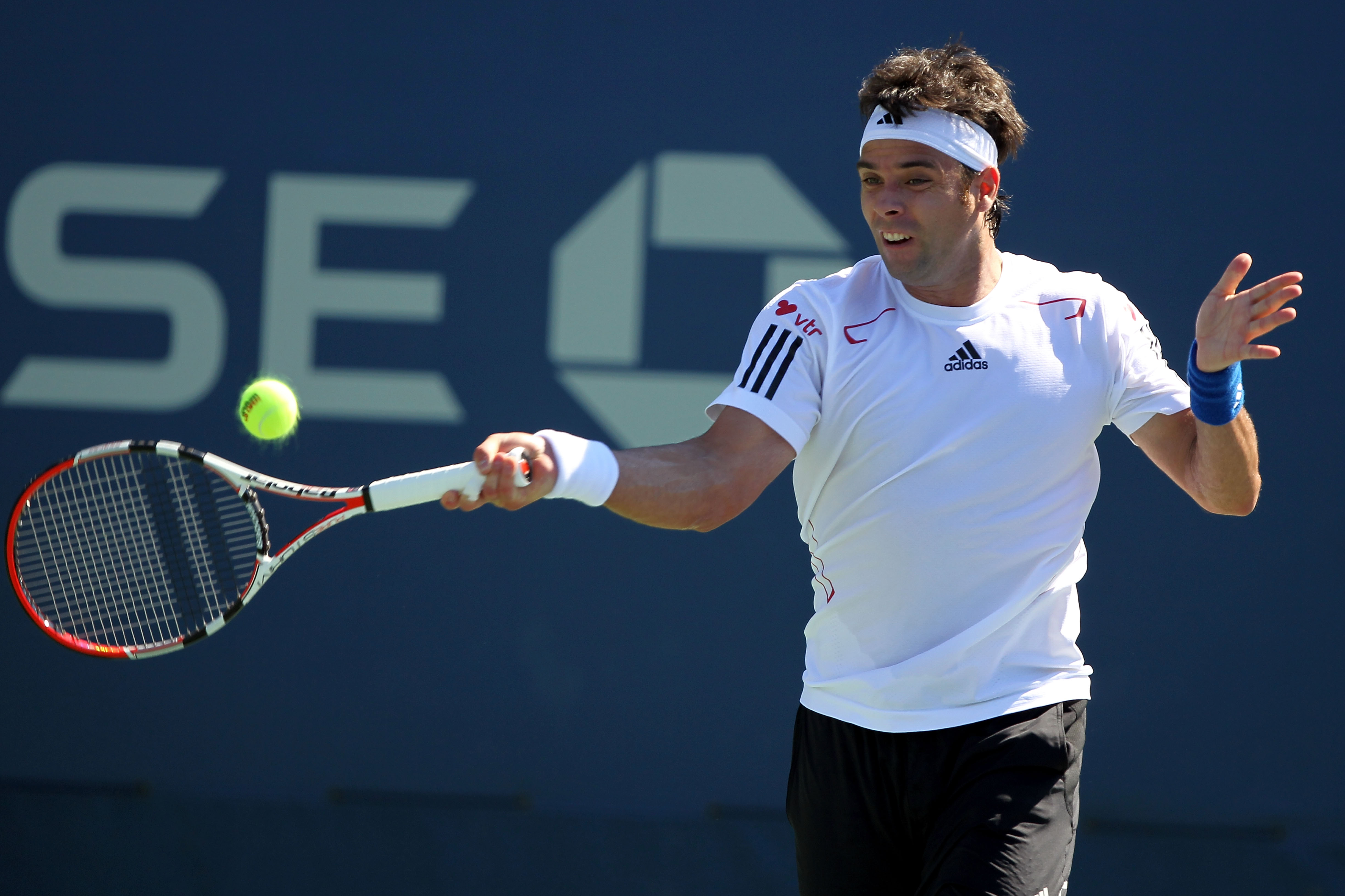 NEW YORK - AUGUST 30:  Fernando Gonzalez of Chile returns a forehand against Ivan Dodig of Croatia in the Men's Singles first round match on day one of the 2010 U.S. Open at the USTA Billie Jean King National Tennis Center on August 30, 2010 in the Flushi