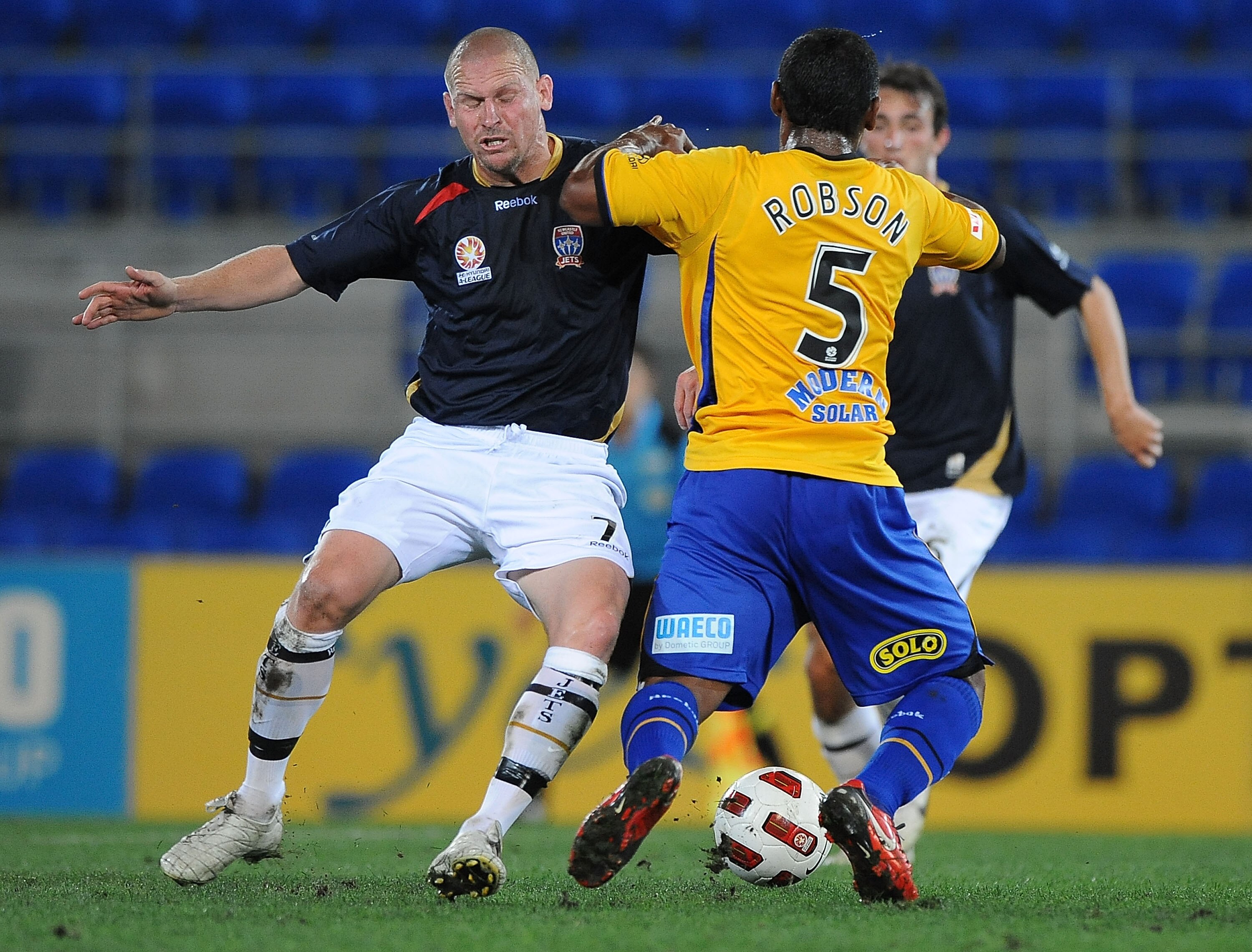 GOLD COAST, AUSTRALIA - SEPTEMBER 22:  Kasey Wehrman of the Jets contests the ball with Robson of the Gold Coast during the round seven A-League match between Gold Coast United and the Newcastle Jets at Skilled Park on September 22, 2010 in Gold Coast, Au