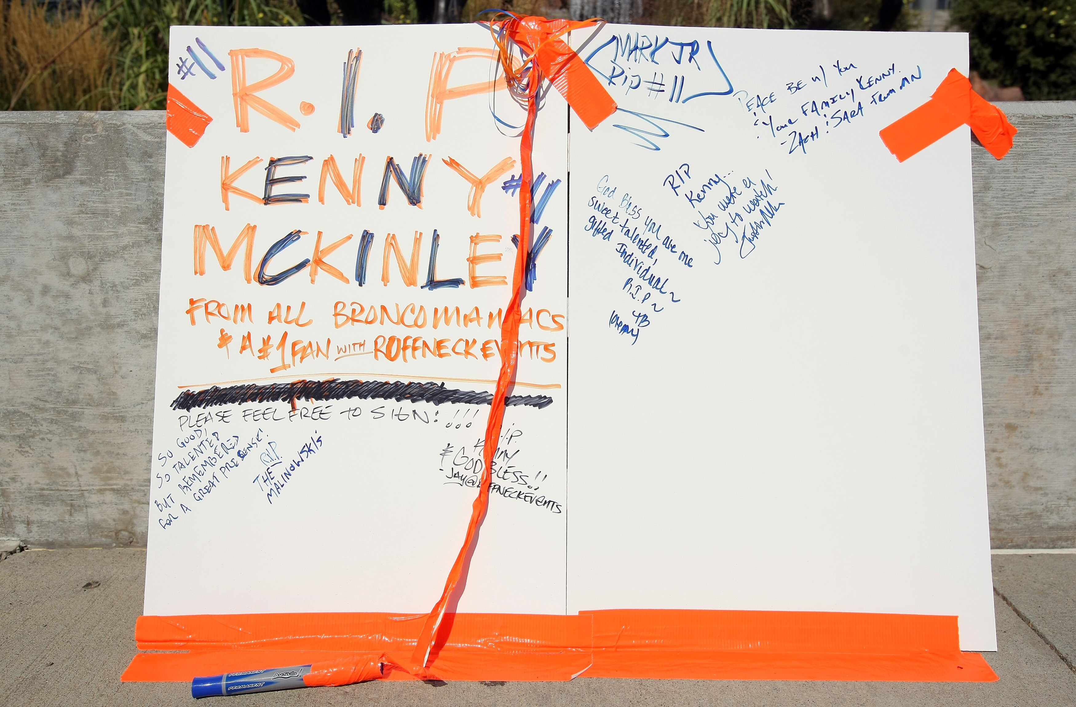 ENGLEWOOD, CO - SEPTEMBER 21:  A poster is placed on the plaza outside stadium for fans to sign in memory of Denver Bronco wide receiver Kenny McKinley at Invesco Field at Mile High on September 21, 2010 in Denver, Colorado. McKinley, 23, was found dead i