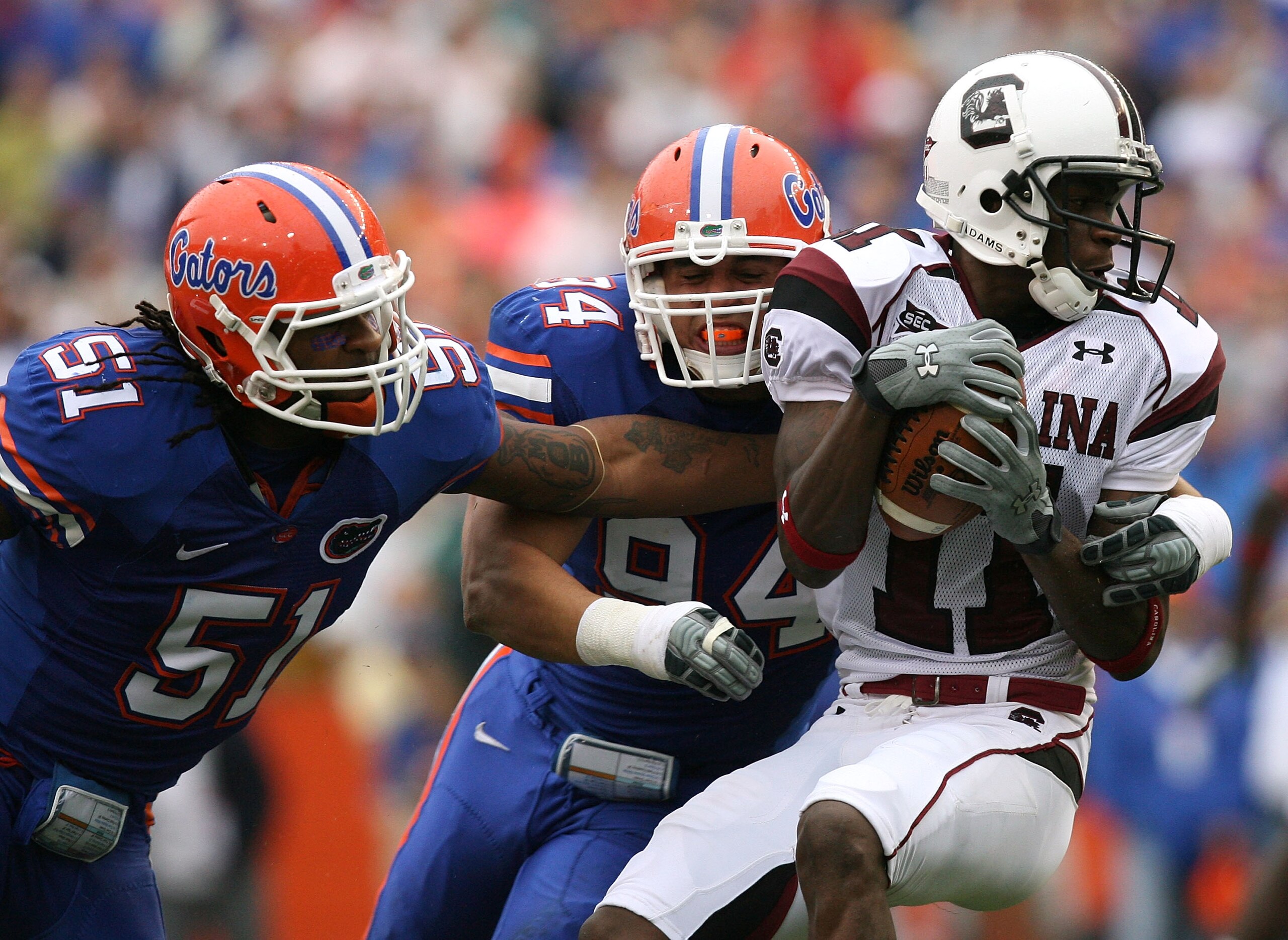 GAINESVILLE, FL - NOVEMBER 15: Linebacker Brandon Spikes #51 and defensive end Justin Trattou #94 of the Florida Gators bring down wide receiver Kenny McKinley #11 of the South Carolina Gamecocks at Ben Hill Griffin Stadium on November 15, 2008 in Gaines GAINESVILLE, FL - NOVEMBER 15: Linebacker Brandon Spikes #51 and defensive end Justin Trattou #94 of the Florida Gators bring down wide receiver Kenny McKinley #11 of the South Carolina Gamecocks at Ben Hill Griffin Stadium on November 15, 2008 in Gaines