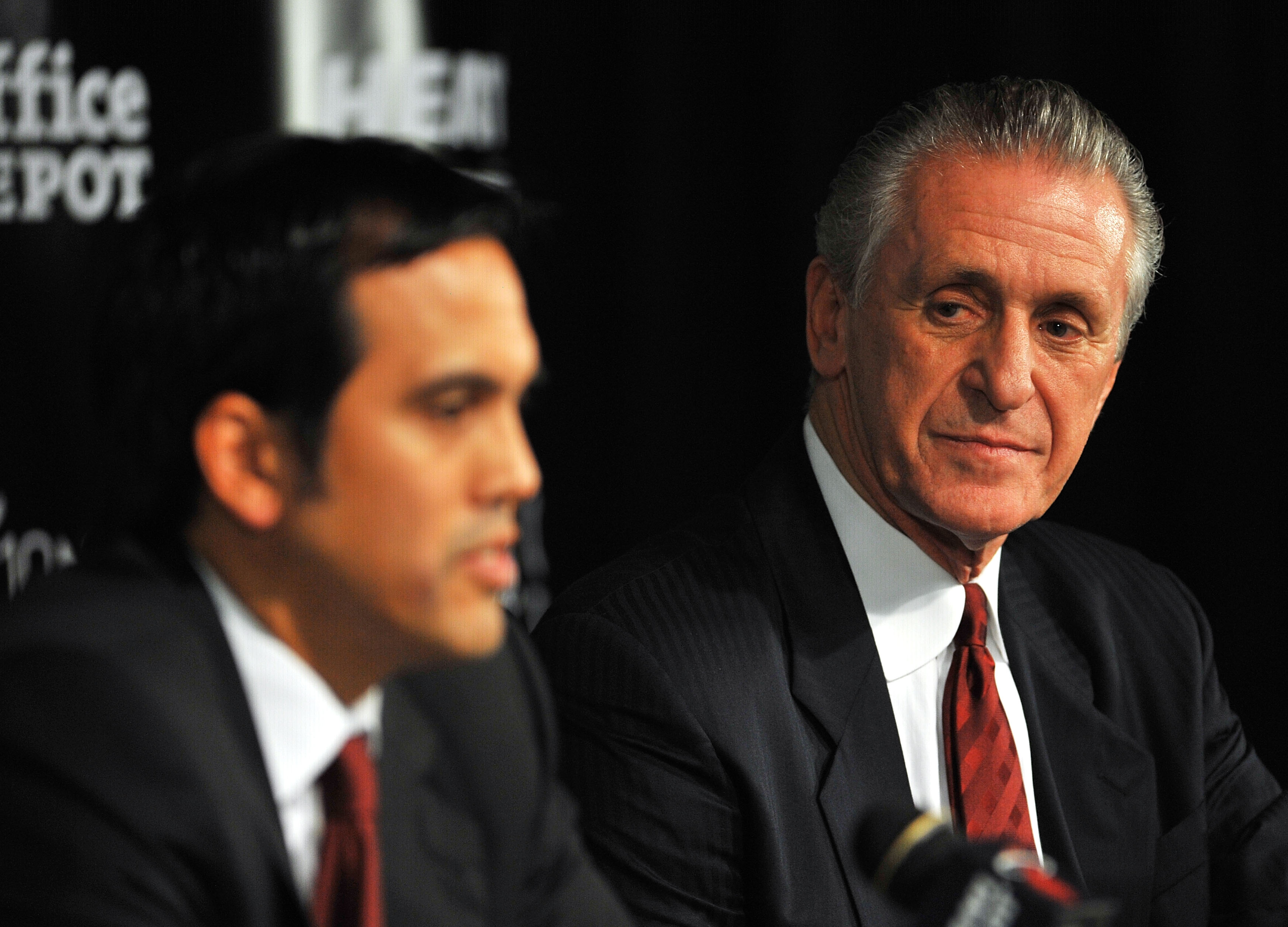 MIAMI - JULY 09:  Head coach Erik Spoelstra (L) and President Pat Riley (R)  of the Miami Heat talk during a press conference after a welcome party for new teammates LeBron James, Dwyane Wade, and Chris Bosh at American Airlines Arena on July 9, 2010 in M