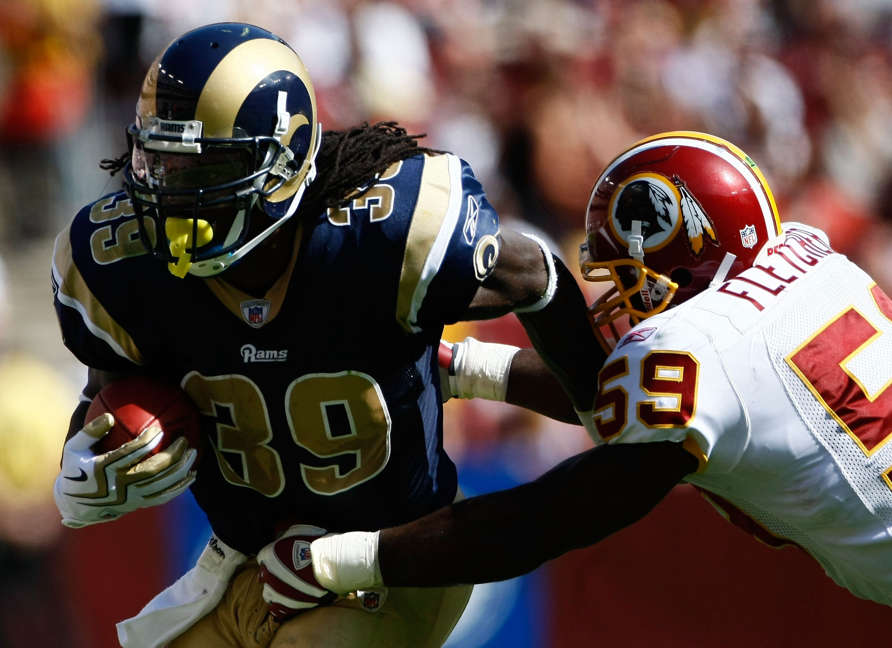 LANDOVER, MD - SEPTEMBER 20:  Steven Jackson #39 of the St. Louis Rams is tackled by London Fletcher #59 of the Washington Redskins during their game on September 20, 2009 at FedEx Field in Landover, Maryland.  The Redskins defeated the Rams by a score of