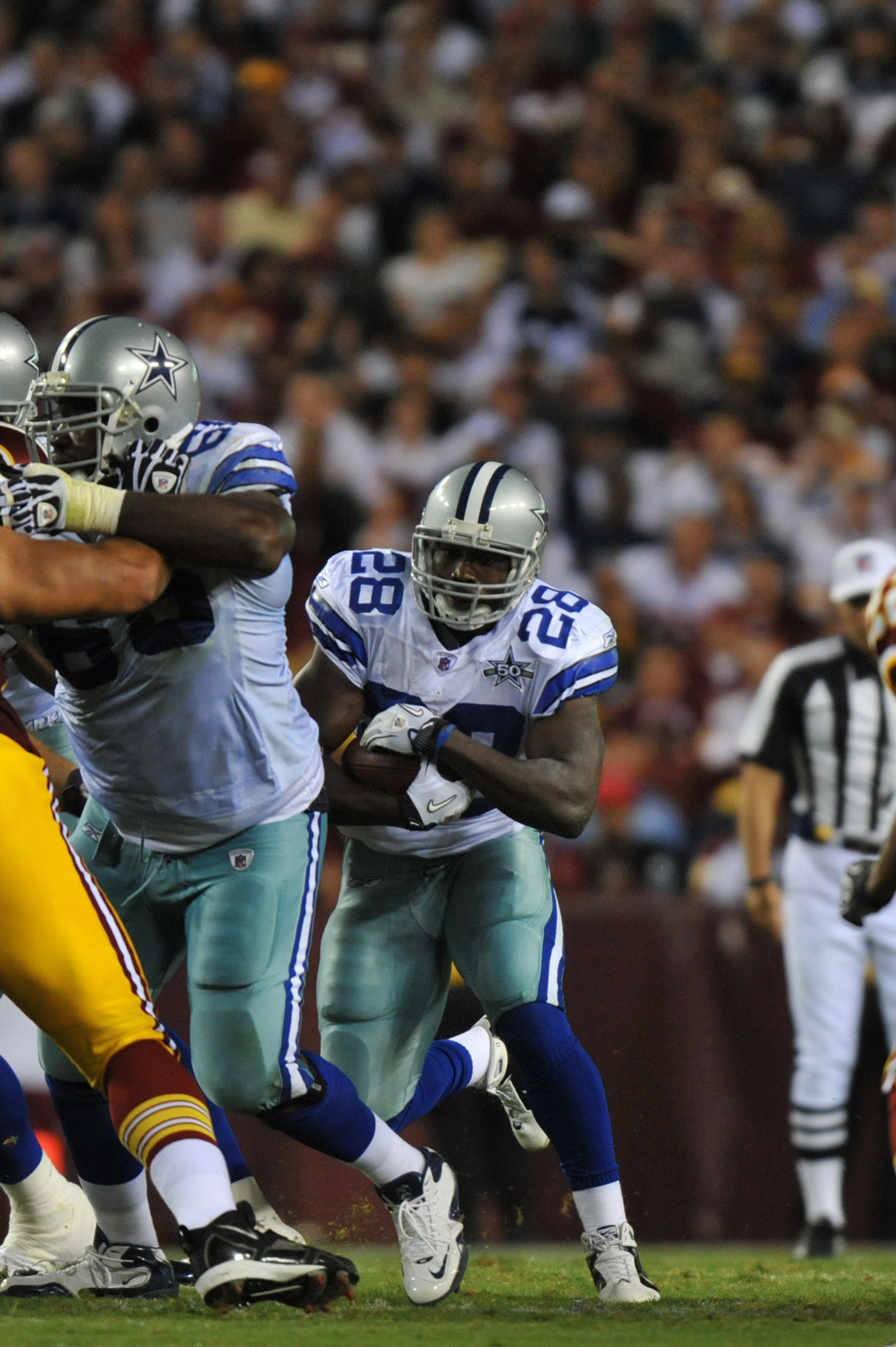 LANDOVER - SEPTEMBER 12:  Felix Jones #28 of the Dallas Cowboys runs the ball during the NFL season opener against the Washington Redskins at FedExField on September 12, 2010 in Landover, Maryland. The Redskins defeated the Cowboys 13-7. (Photo by Larry F
