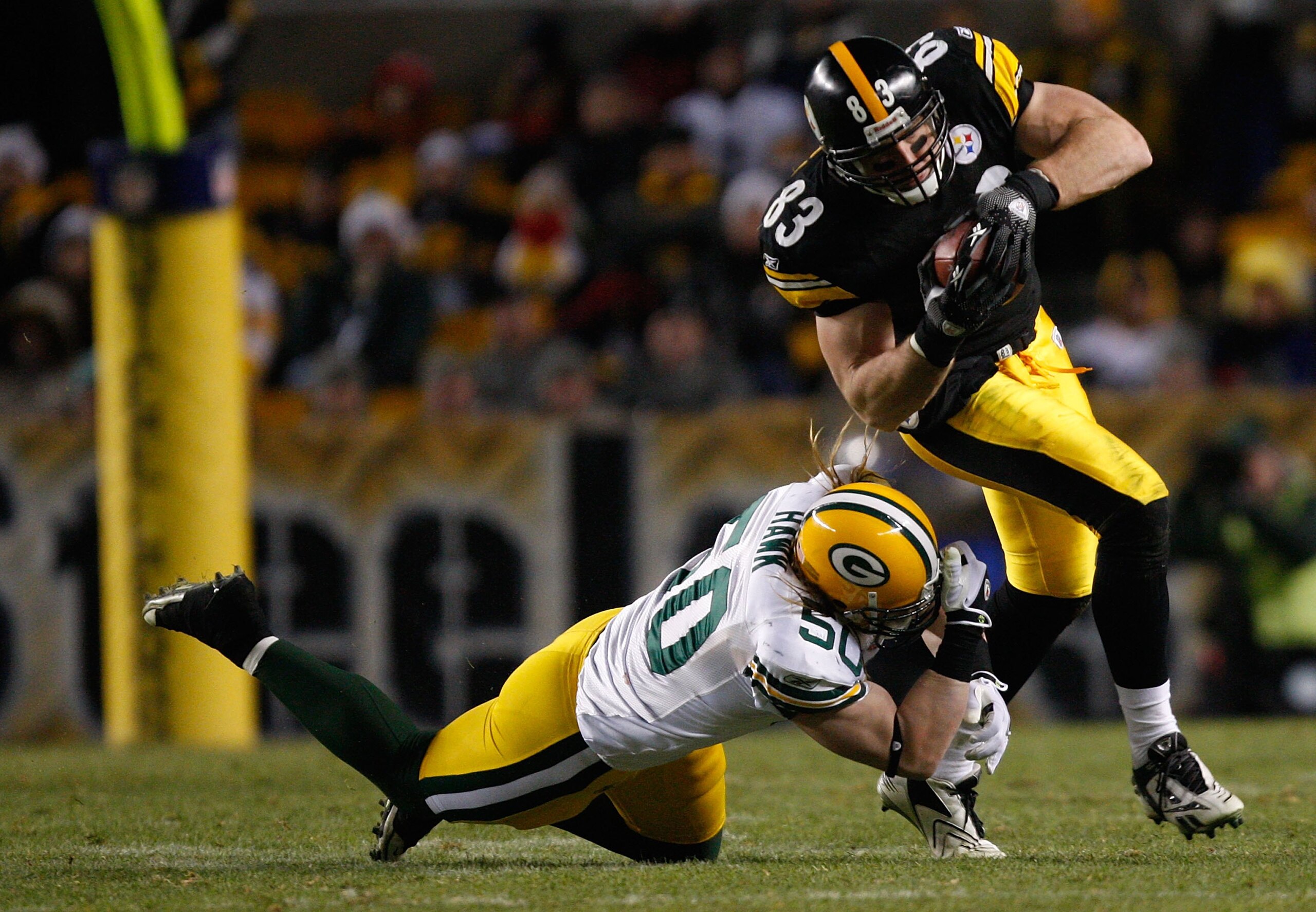 PITTSBURGH - DECEMBER 20: Heath Miller #83 of the Pittsburgh Steelers attempts to break through a tackle by AJ Hawk #50 of the Green Bay Packers during the game on December 20, 2009 at Heinz Field in Pittsburgh, Pennsylvania. (Photo by Jared Wickerham/Get