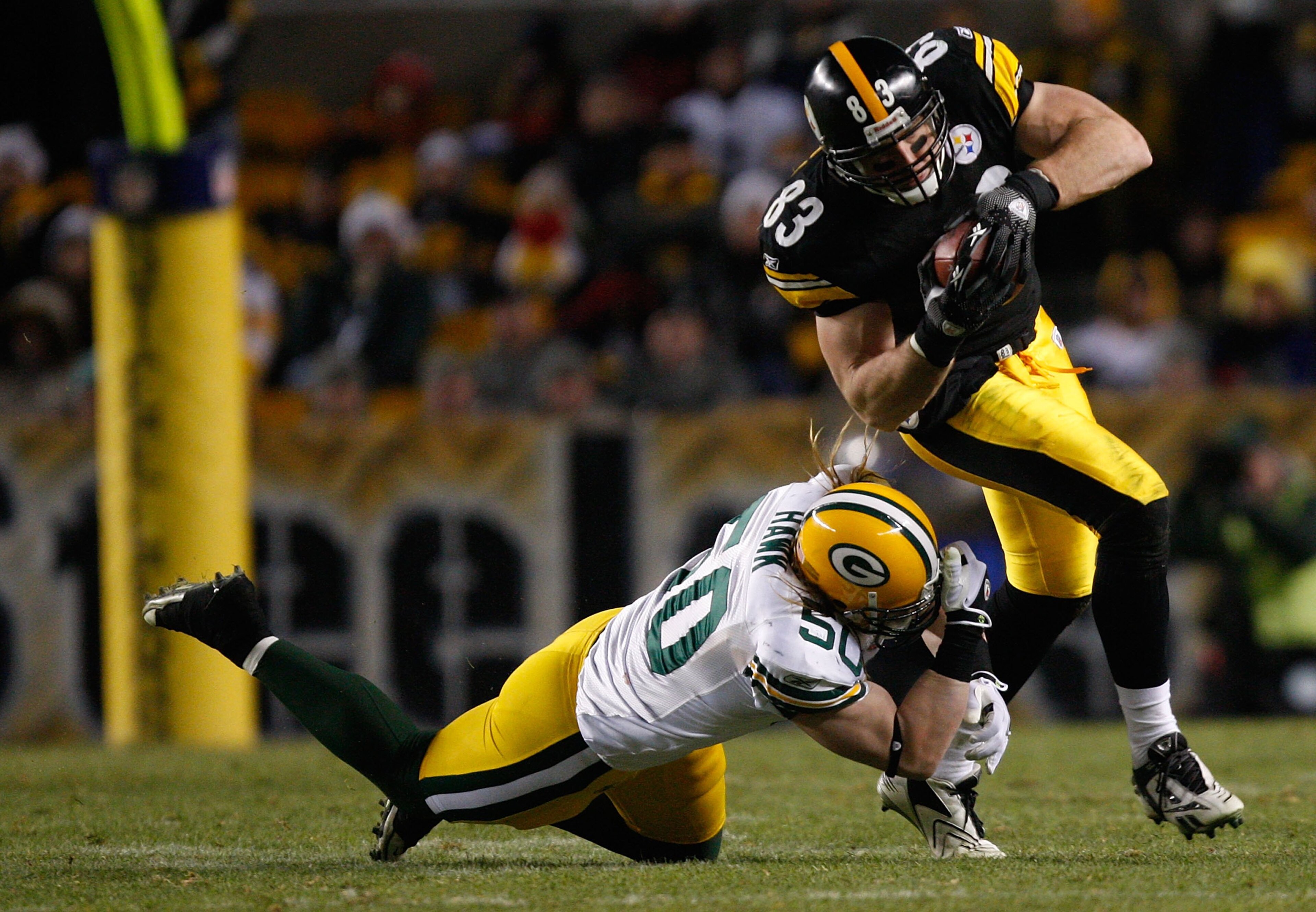 PITTSBURGH - DECEMBER 20: Heath Miller #83 of the Pittsburgh Steelers attempts to break through a tackle by AJ Hawk #50 of the Green Bay Packers during the game on December 20, 2009 at Heinz Field in Pittsburgh, Pennsylvania. (Photo by Jared Wickerham/Get
