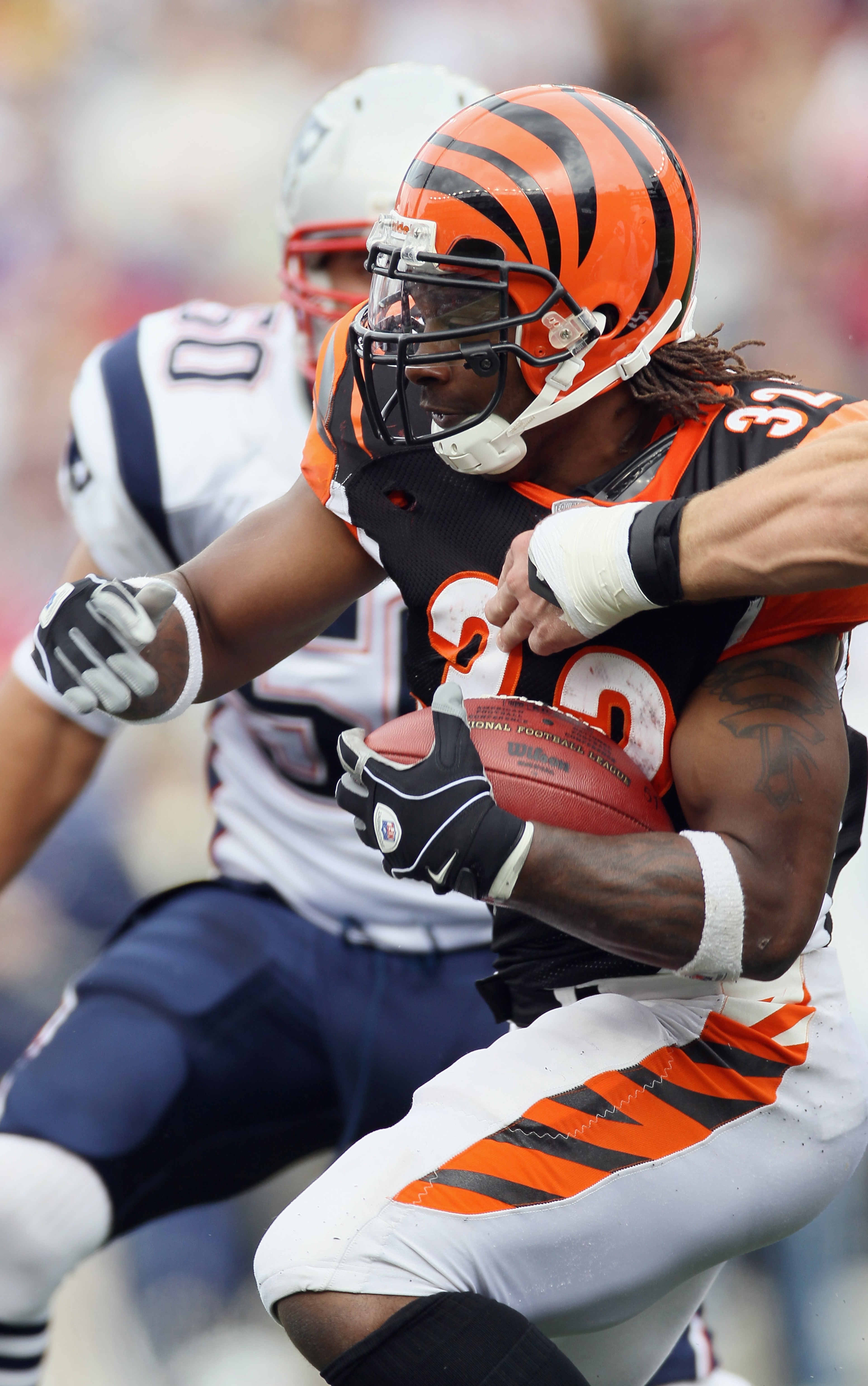 FOXBORO, MA - SEPTEMBER 12: Cedric Benson #32 of the Cincinnati Bengals carries the ball against the New England Patriots during the NFL season opener on September 12, 2010 at Gillette Stadium in Foxboro, Massachusetts.  (Photo by Elsa/Getty Images)