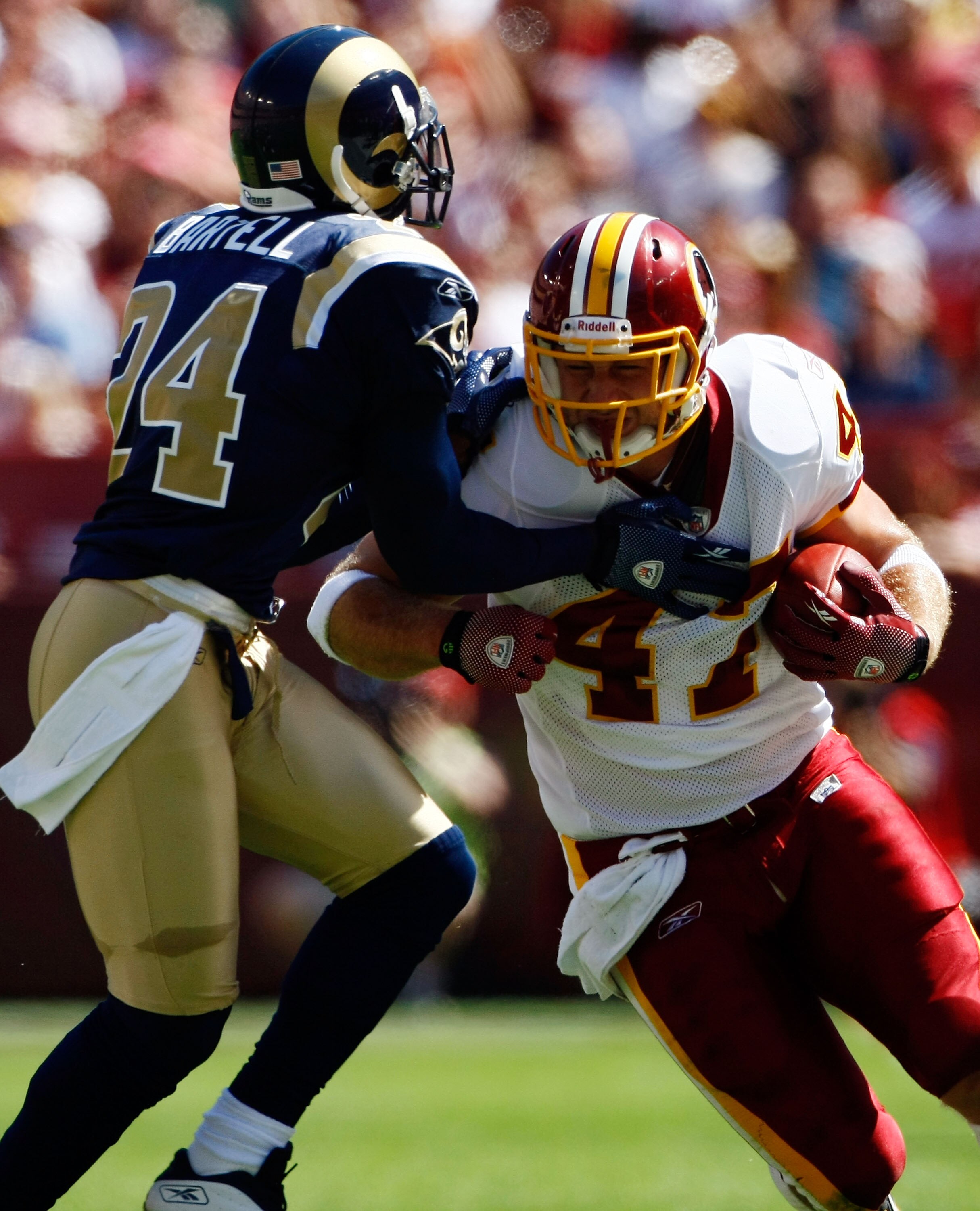LANDOVER, MD - SEPTEMBER 20:  Chris Cooley #47 of the Washington Redskins carries the ball upfield as Ron Bartell #24 of the St. Louis Rams makes the tackle during their game on September 20, 2009 at FedEx Field in Landover, Maryland.  (Photo by Win McNam