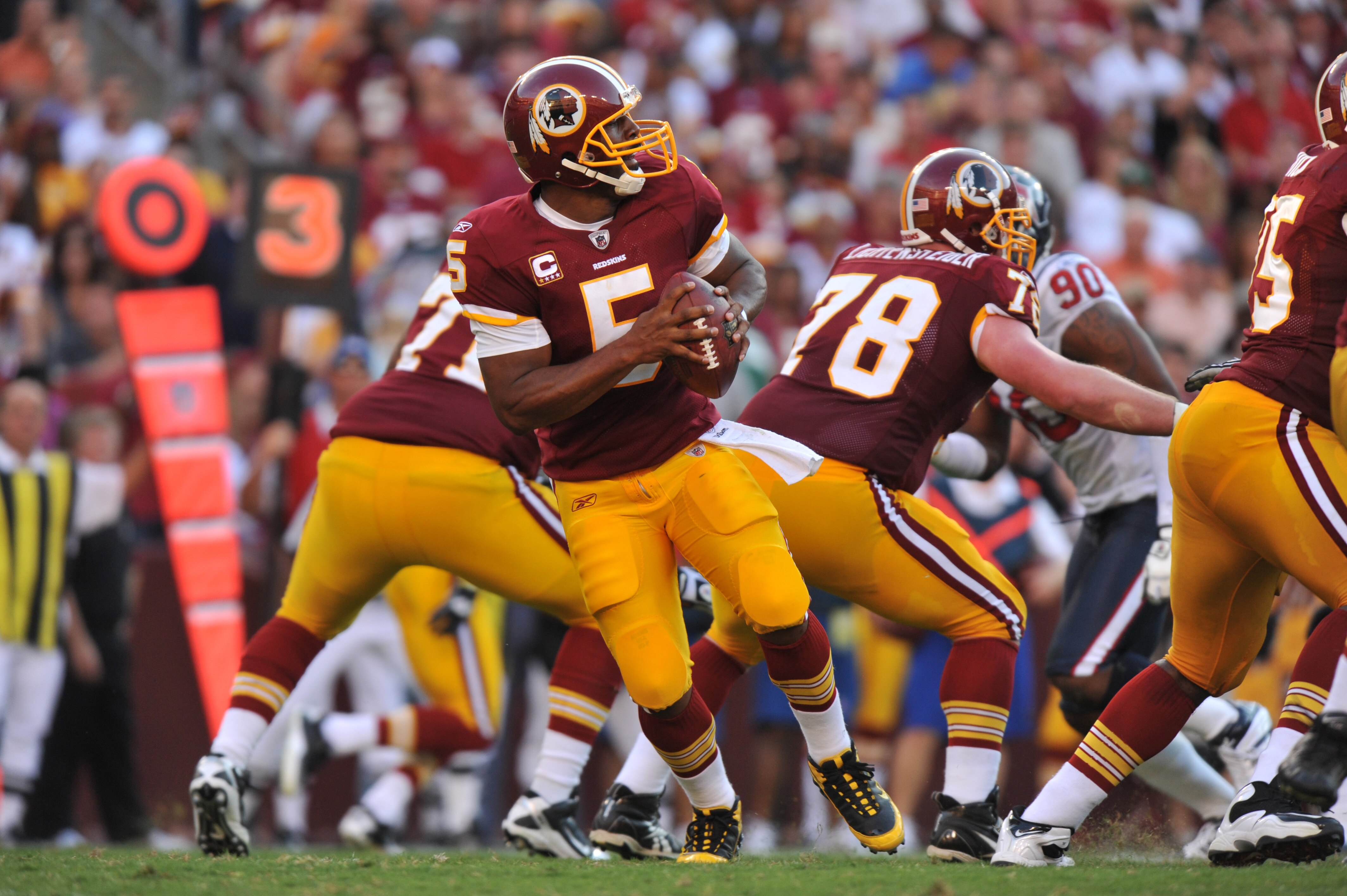LANDOVER, MD - SEPTEMBER 19:  Donovan McNabb #5 of the Washington Redskins looks for a receiver during the game against the Houston Texans at FedExField on September 19, 2010 in Landover, Maryland. The Texans defeated the Redskins in overtime 30-27. (Phot