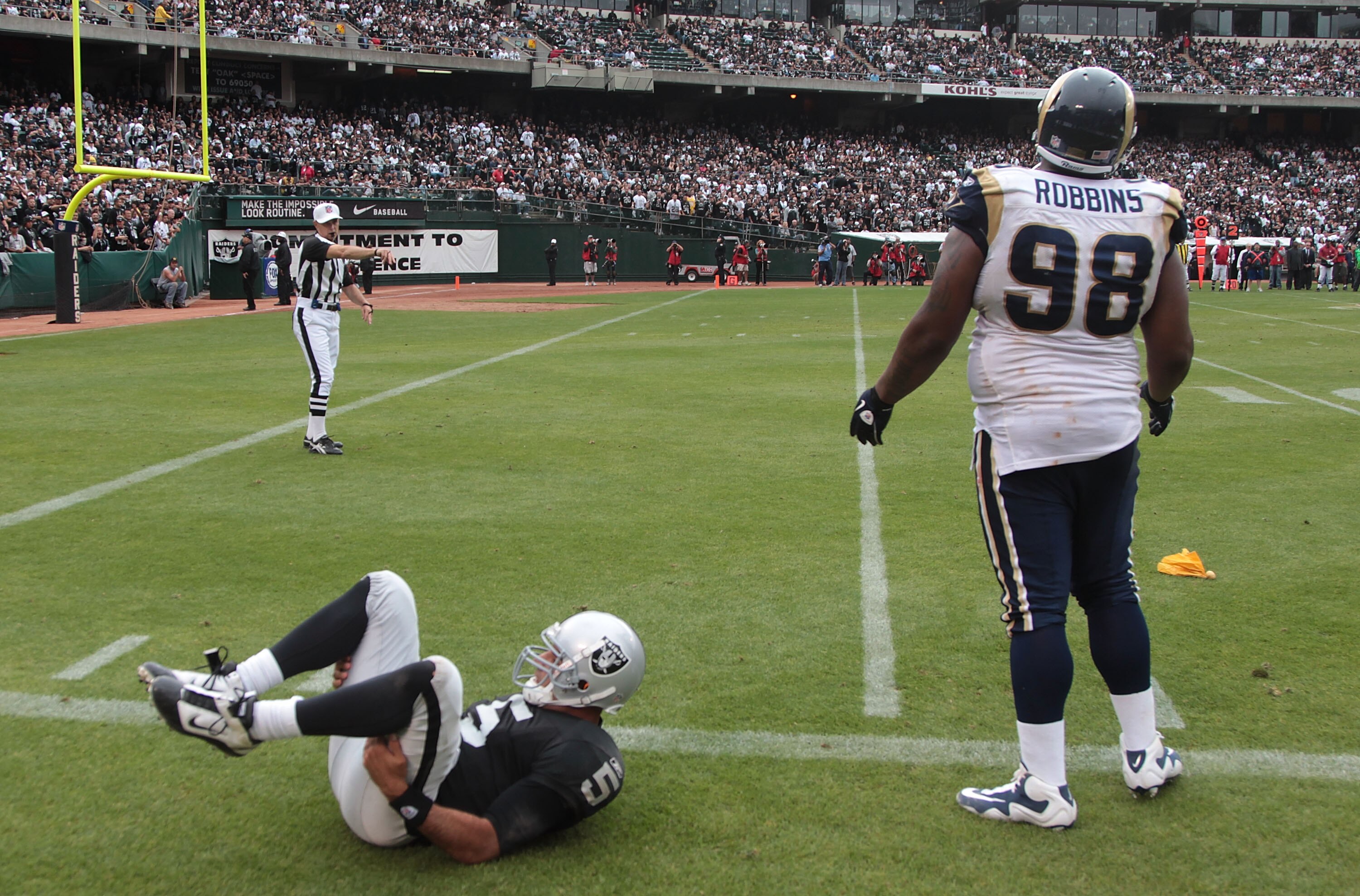 OAKLAND, CA - SEPTEMBER 19:  Fred Robbins #98 of the St. Louis Rams is called for a roughing the passer penalty against Bruce Gradkowski #5 of the Oakland Raiders during an NFL game at Oakland-Alameda County Coliseum on September 19, 2010 in Oakland, Cali