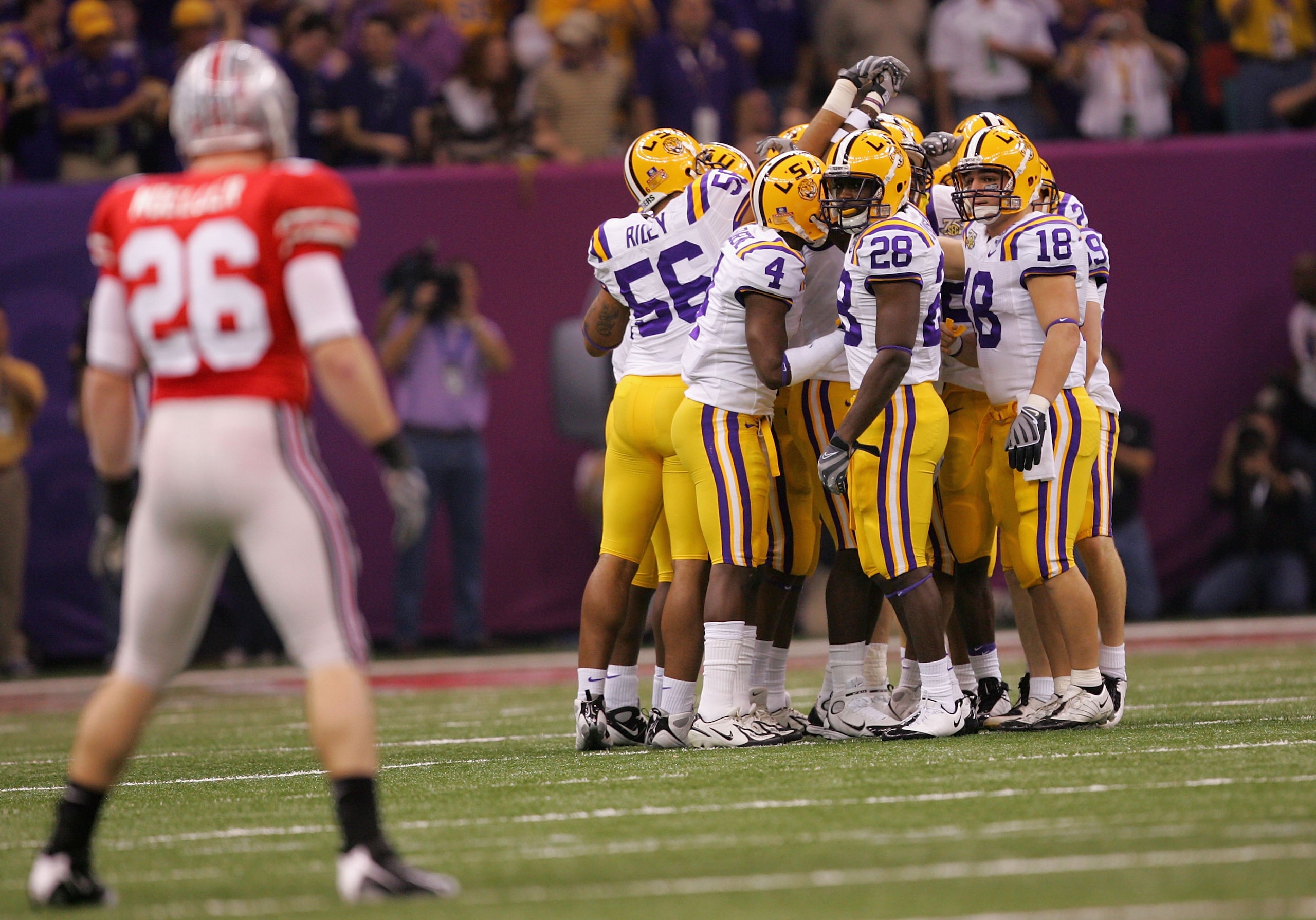 NEW ORLEANS - JANUARY 07:  The Louisiana State University Tigers huddle up as Tyler Moeller #26 of the Ohio State Buckeyes looks on before the AllState BCS National Championship on January 7, 2008 at the Louisiana Superdome in New Orleans, Louisiana.  (Ph
