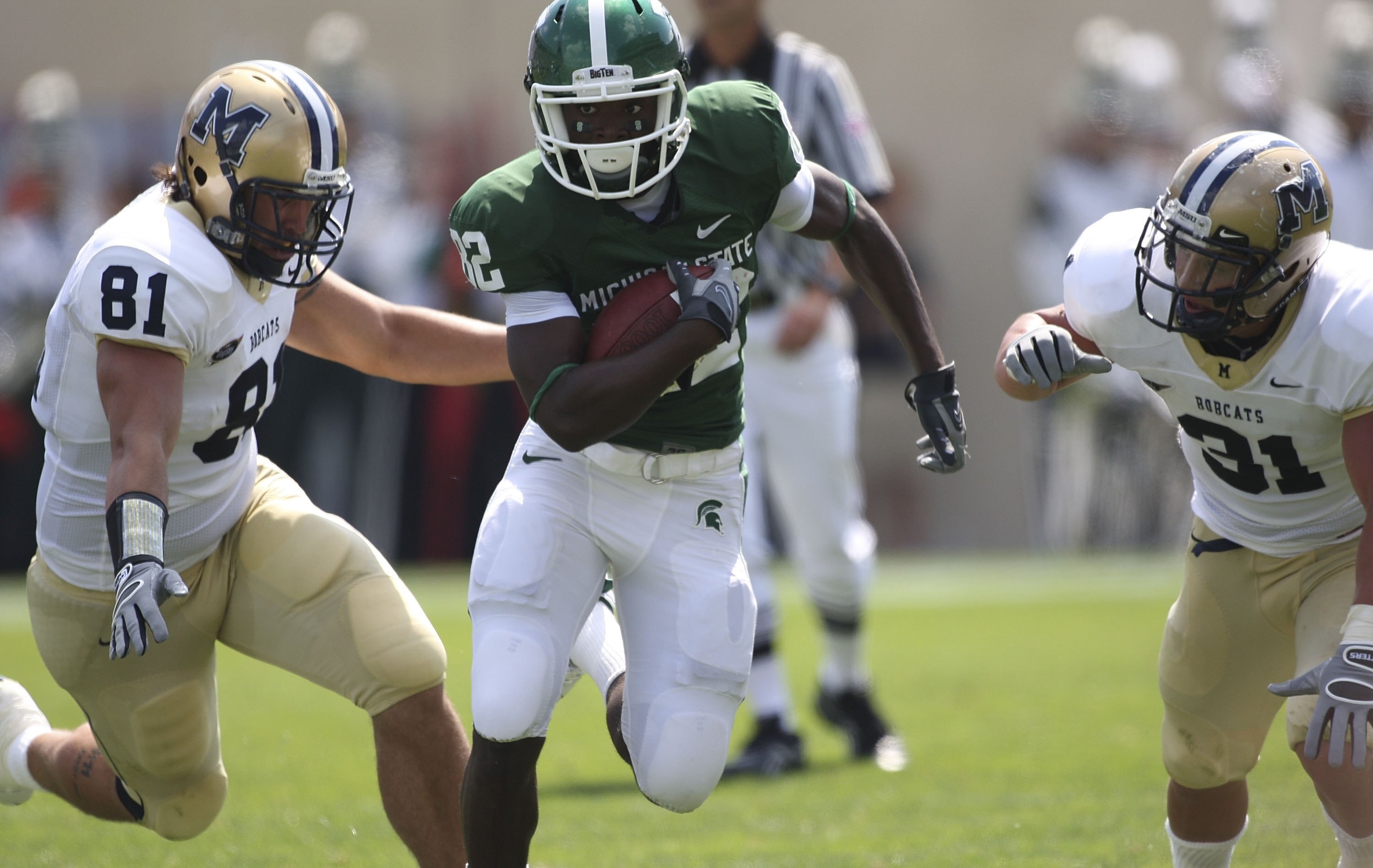 EAST LANSING, MI - SEPTEMBER 05:  Wide receiver Keshawn Martin #82 of the Michigan State Spartans runs for a first down in the second quarter as Kyle Begger #81 of Montana State attempts to make the stop on September 5, 2009 at Spartan Stadium in East Lan