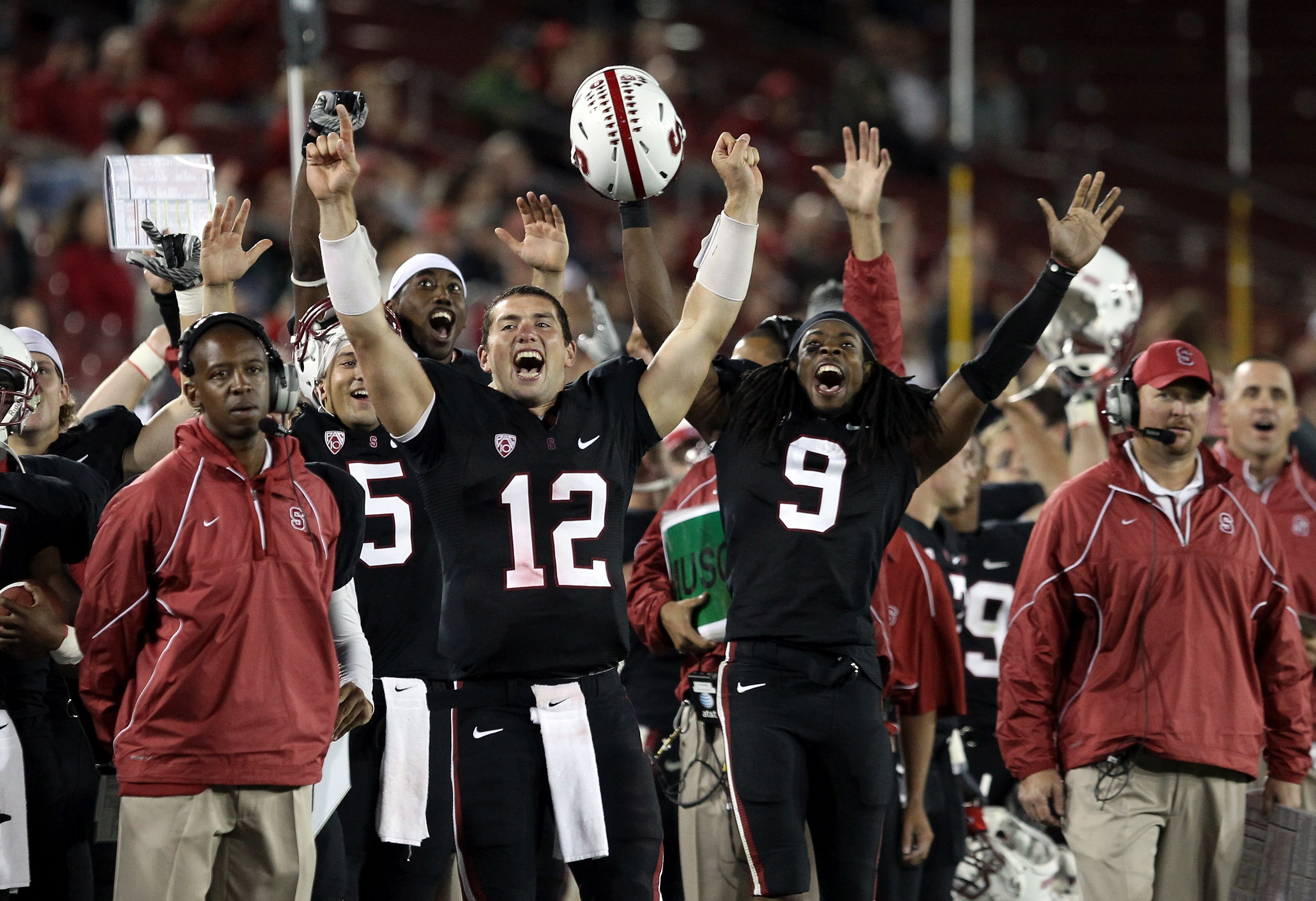 PALO ALTO, CA - SEPTEMBER 18:  Andrew Luck #12 and Richard Sherman #9 of the Stanford Cardinal celebrate from the sidelines after Stanford scored a touchdown to go up 67-24 in the fourth quarter of their game against the Wake Forest Demon Deacons at Stanf