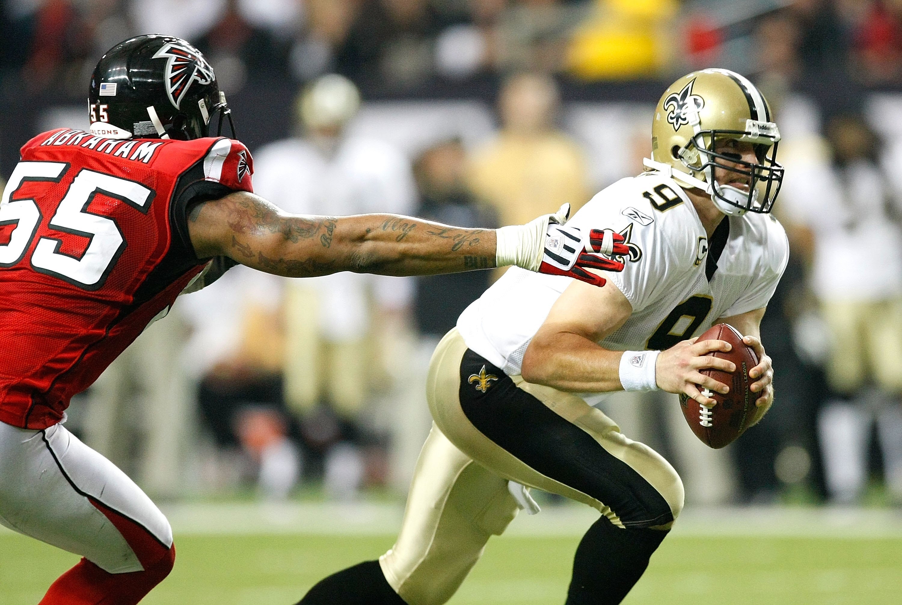 ATLANTA - DECEMBER 13:  Quarterback Drew Brees #9 of the New Orleans Saints against John Abraham #55 of the Atlanta Falcons at Georgia Dome on December 13, 2009 in Atlanta, Georgia.  (Photo by Kevin C. Cox/Getty Images)